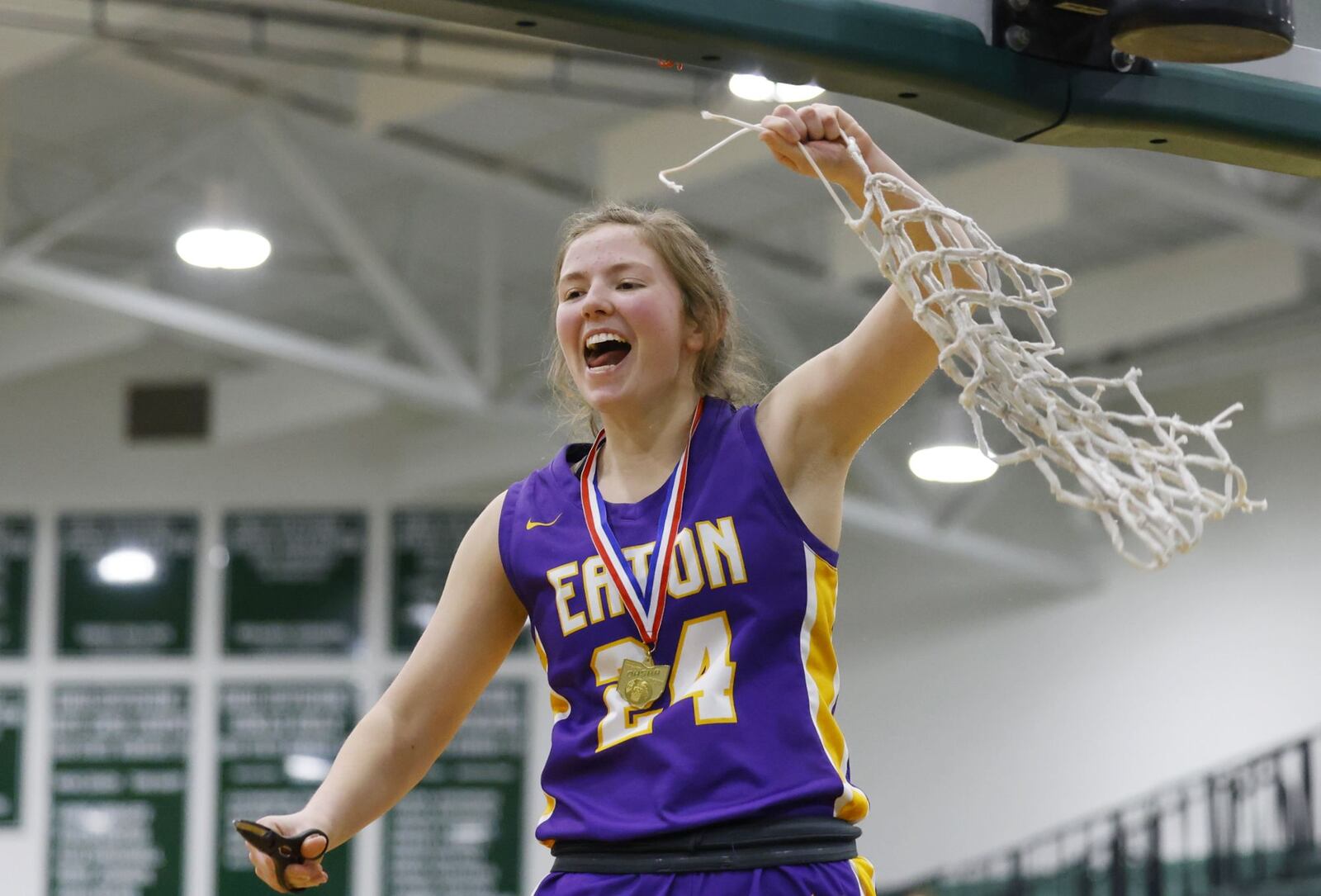 Eaton's Allison Mowen cuts down the net after Eaton defeated Summit Country Day 43-35 in their Division II district final basketball game Friday, Feb. 25, 2022 at Mason Middle School. NICK GRAHAM/STAFF