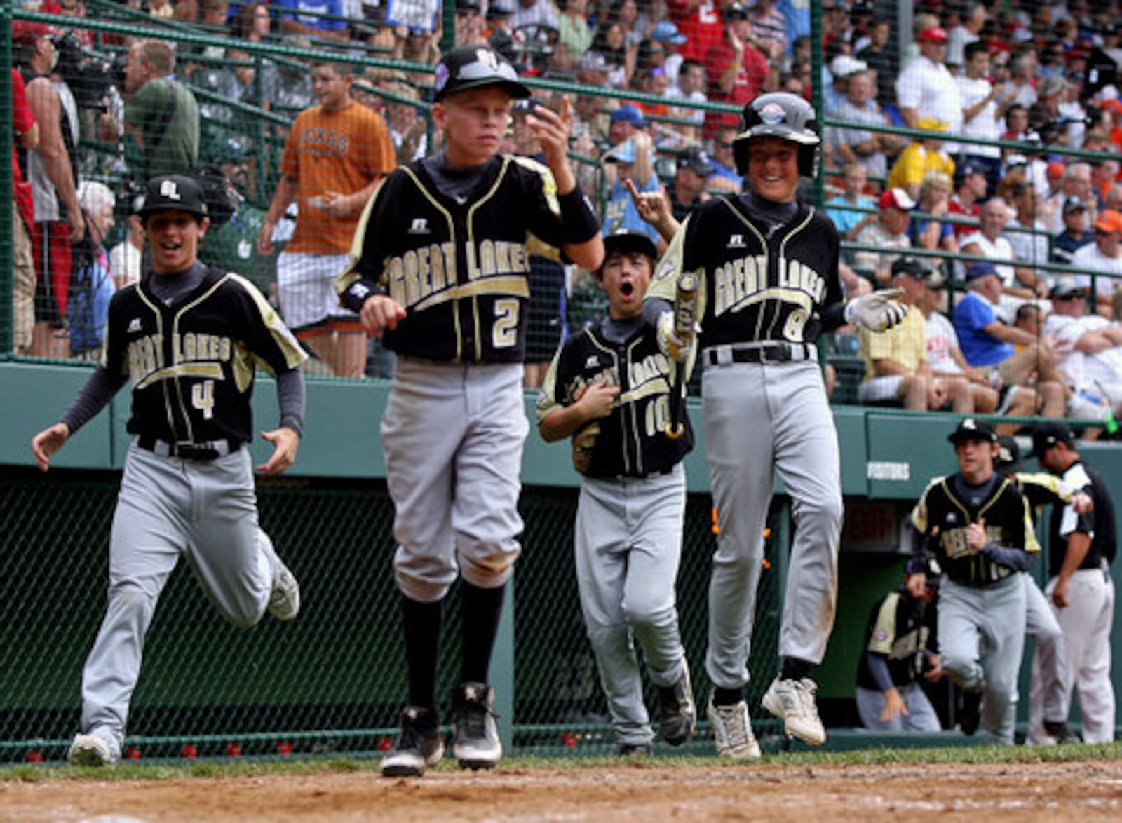 Hamilton West Side clears the bench to celebrate Jake Jones' second home run in the fourth-inning of Saturday's game against Toms River, N.J., at Howard J. Lamade Stadium in South Williamsport, PA.