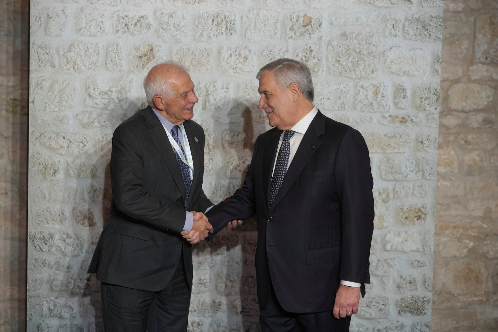 Italian Foreign Minister Antonio Tajani, right, greets European Union foreign policy chief Josep Borrell as he arrives for a family photo at the G7 of foreign Ministers in Anagni, some 70 kilometers south-east of Rome, Monday, Nov. 25, 2024. (AP Photo/Alessandra Tarantino)