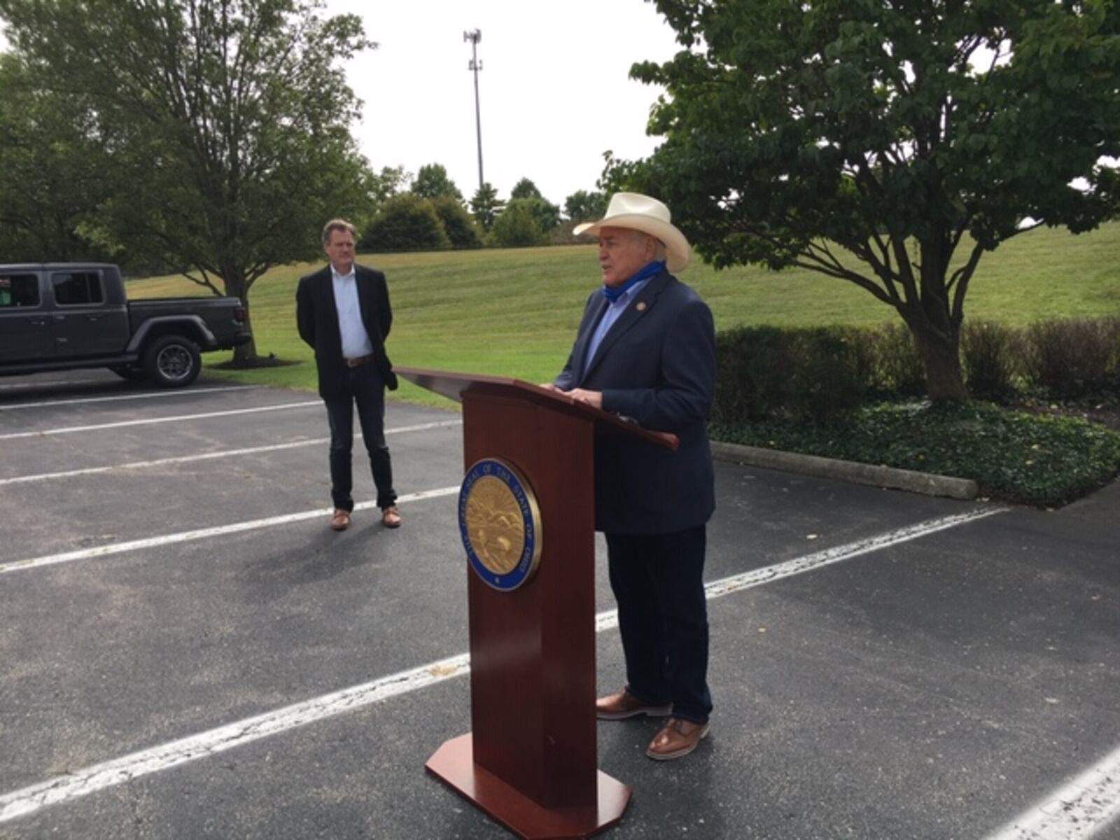 U.S. Rep. John Carter, R-Texas, speaks at a podium Monday at Wright-Patterson Air Force Base. U.S. Rep. Mike Turner, R-Dayton, looks on from Carter's right. THOMAS GNAU/STAFF