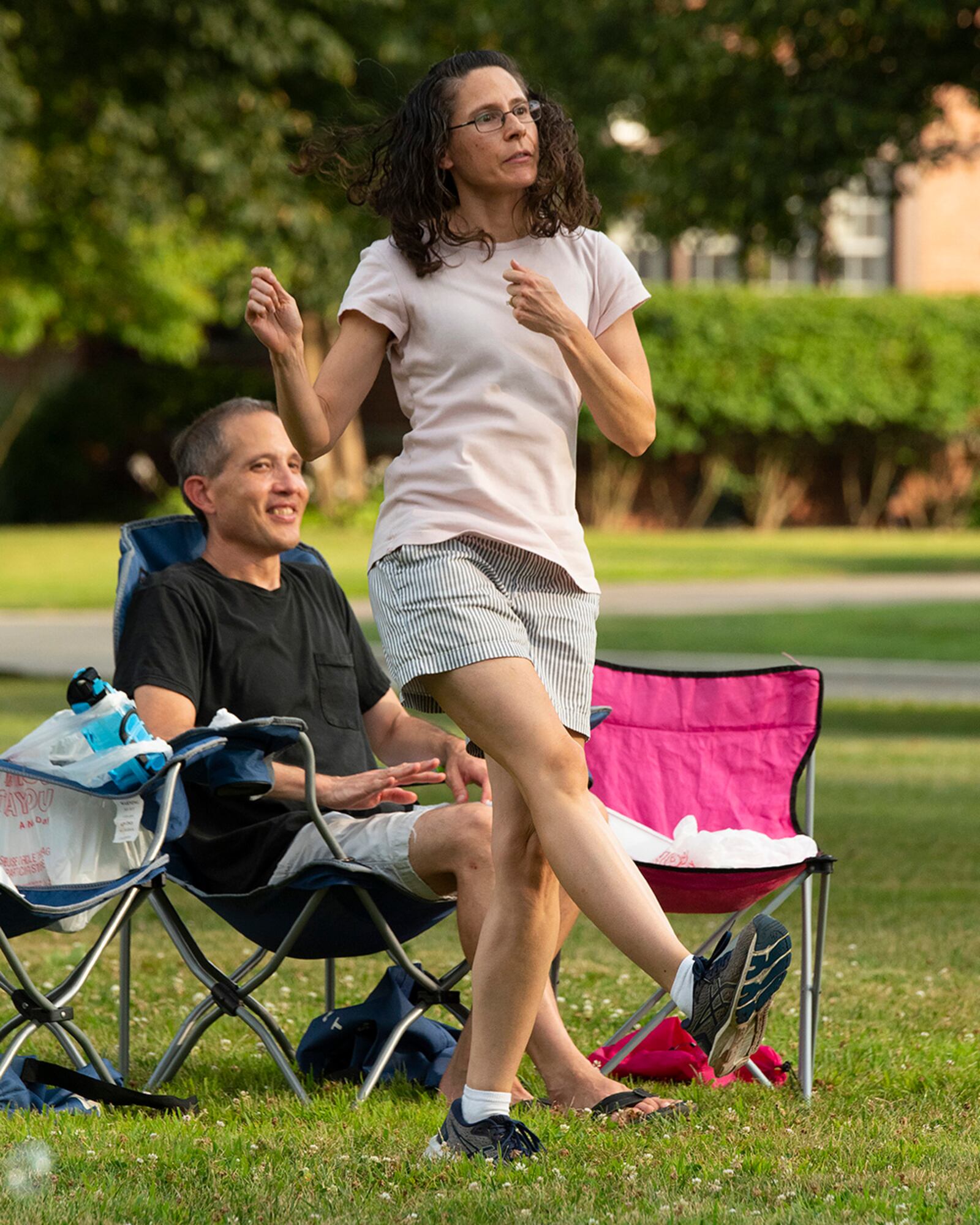 Melissa Nishikawa dances as her husband, Col. Brett Nishikawa, 711th Human Performance Wing, watches Aug. 12 at a block party by Turtle Pond in the historic Brick Quarters housing area at Wright-Patterson Air Force Base. U.S. AIR FORCE PHOTO/R.J. ORIEZ