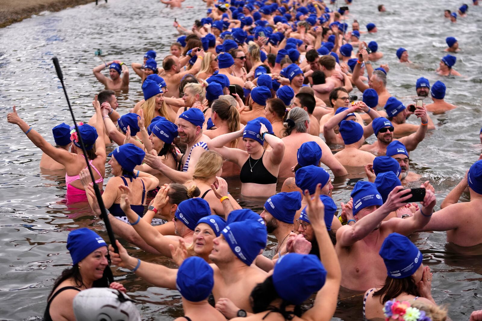 Some of 2461 polar swimmers wait in the water to set a world record for the largest polar bear dip at a lake in Most, Czech Republic, Saturday, March 1, 2025. (AP Photo/Petr David Josek)