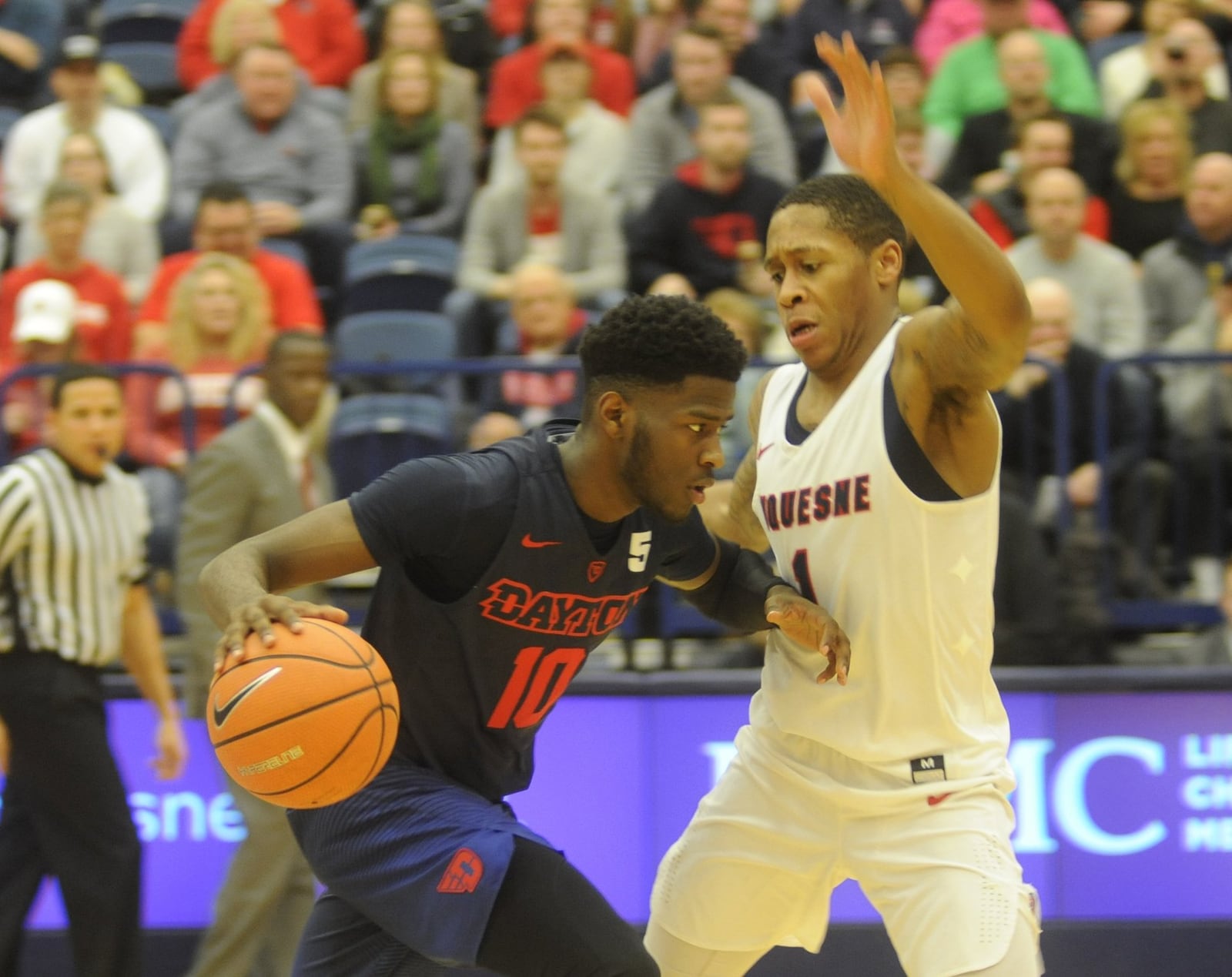 Dayton’s Jalen Crutcher (with ball) drives on Mike Lewis II. Duquesne hosted Dayton at Pittsburgh in a men’s college basketball A-10 opener on Sat., Dec. 30, 2017. MARC PENDLETON / STAFF