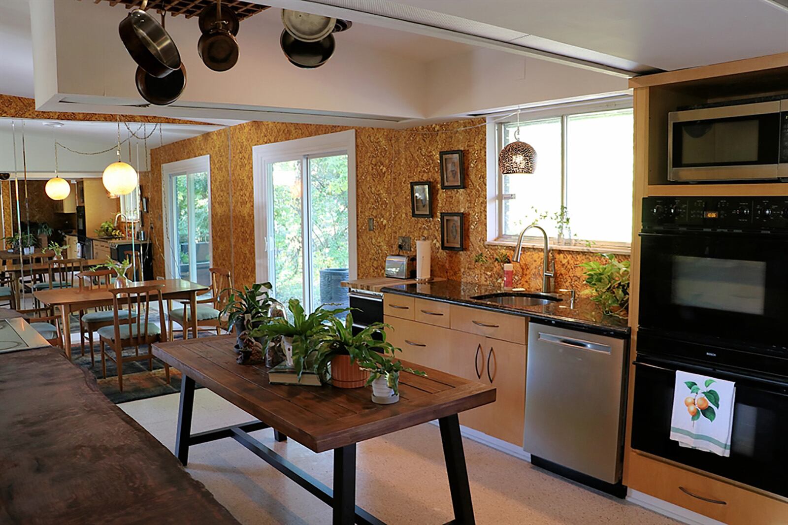 The galley kitchen has light wood contemporary cabinetry that fills two walls and provides plenty of work space. A hand-carved wood countertop flanks the cooktop and warming oven. CONTRIBUTED PHOTO BY KATHY TYLER