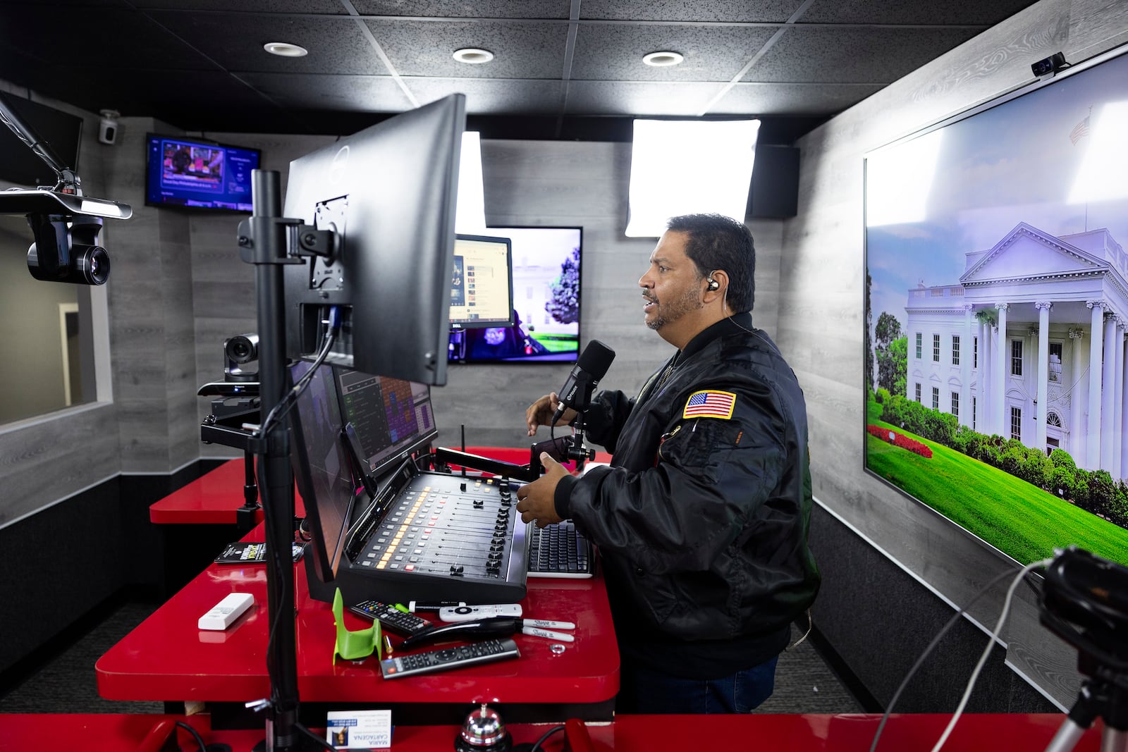 Radio host and owner of radio station La Mega 101.7 FM Victor Martinez on the air in Allentown, Pa., Tuesday, Oct. 15, 2024. (AP Photo/Ryan Collerd)