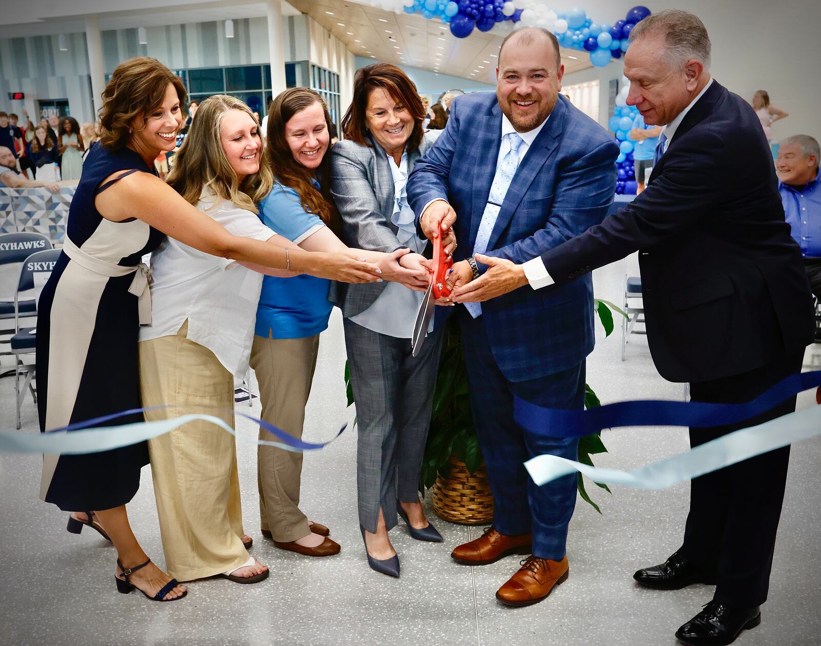 Hundreds of people attended the ribbon cutting ceremony and open house of the new Fairborn High School, Wednesday, July 17, 2024. From right in this photo are Superintendent Gene Lolli, outgoing FHS principal Waylon Stegall, and incoming principal Karen Chicketti. MARSHALL GORBY\STAFF