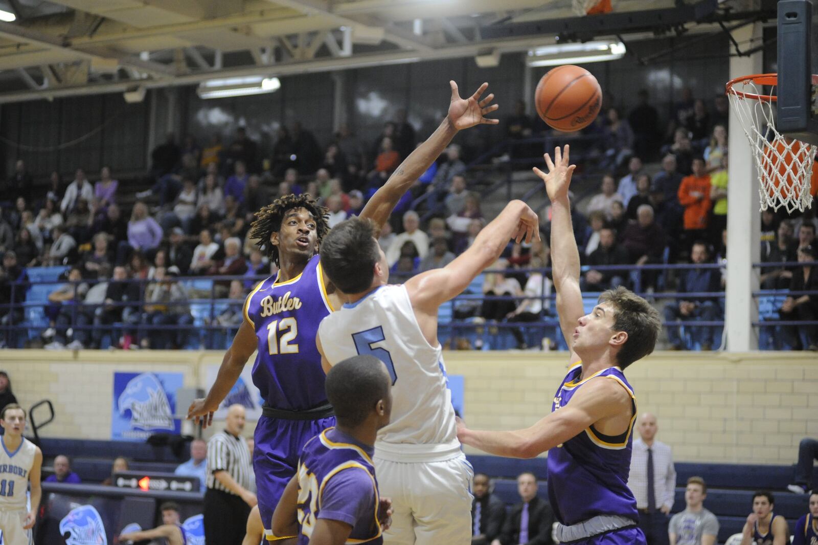 Fairborn’s Joe Nickel (5) draws Butler defenders Bryant Johnson (left) and Michael Kreill (right). Butler defeated host Fairborn 68-53 in a boys high school basketball game on Friday, Jan. 4, 2019. MARC PENDLETON / STAFF