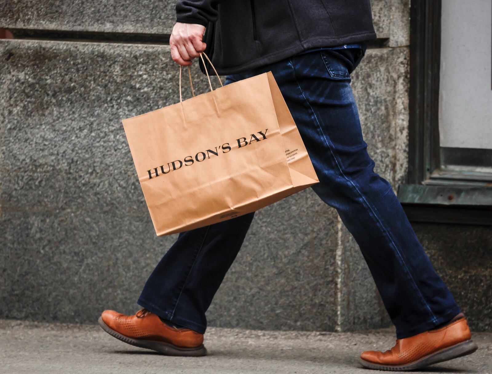 A shopper leaves the Hudson's Bay store in downtown Calgary, Alberta, Thursday, March 20, 2025. (Jeff McIntosh/The Canadian Press via AP)