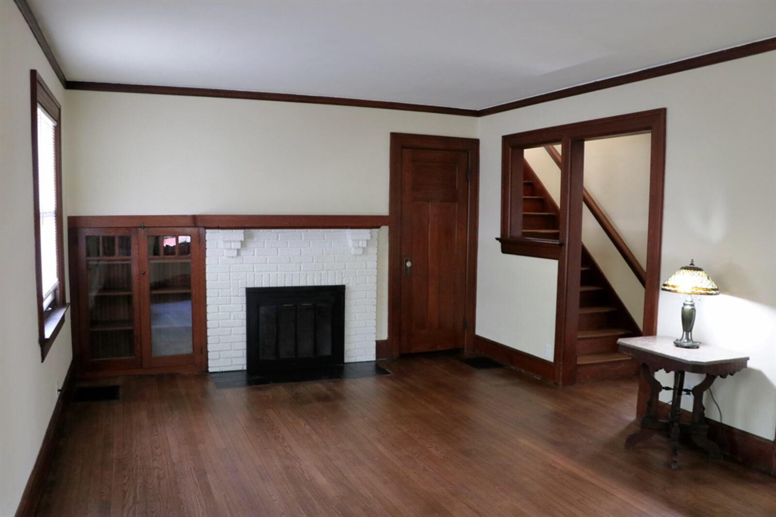 The front door opens into the formal living room with the focal point being the brick fireplace with built-in cabinetry. 