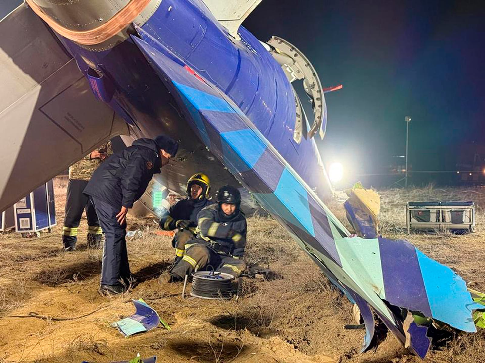 In this photo released by Kazakhstan's Emergency Ministry Press Service, rescuers work at the wreckage of Azerbaijan Airlines Embraer 190 lies on the ground near the airport of Aktau, Kazakhstan, Thursday, Dec. 26, 2024. (Kazakhstan's Emergency Ministry Press Service via AP)