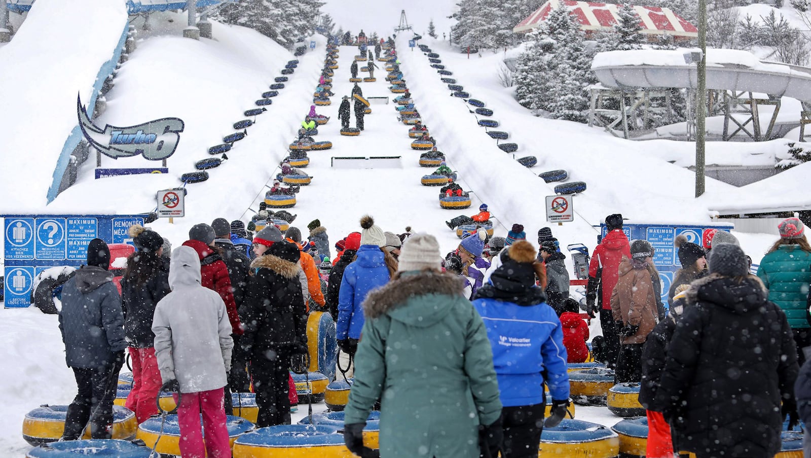 Visitors to Valcartier Winter Park wait to ride the inner tube lift. Just plop down and belts will take you to the top.  (Brian Sirimaturos/St. Louis Post-Dispatch/TNS)