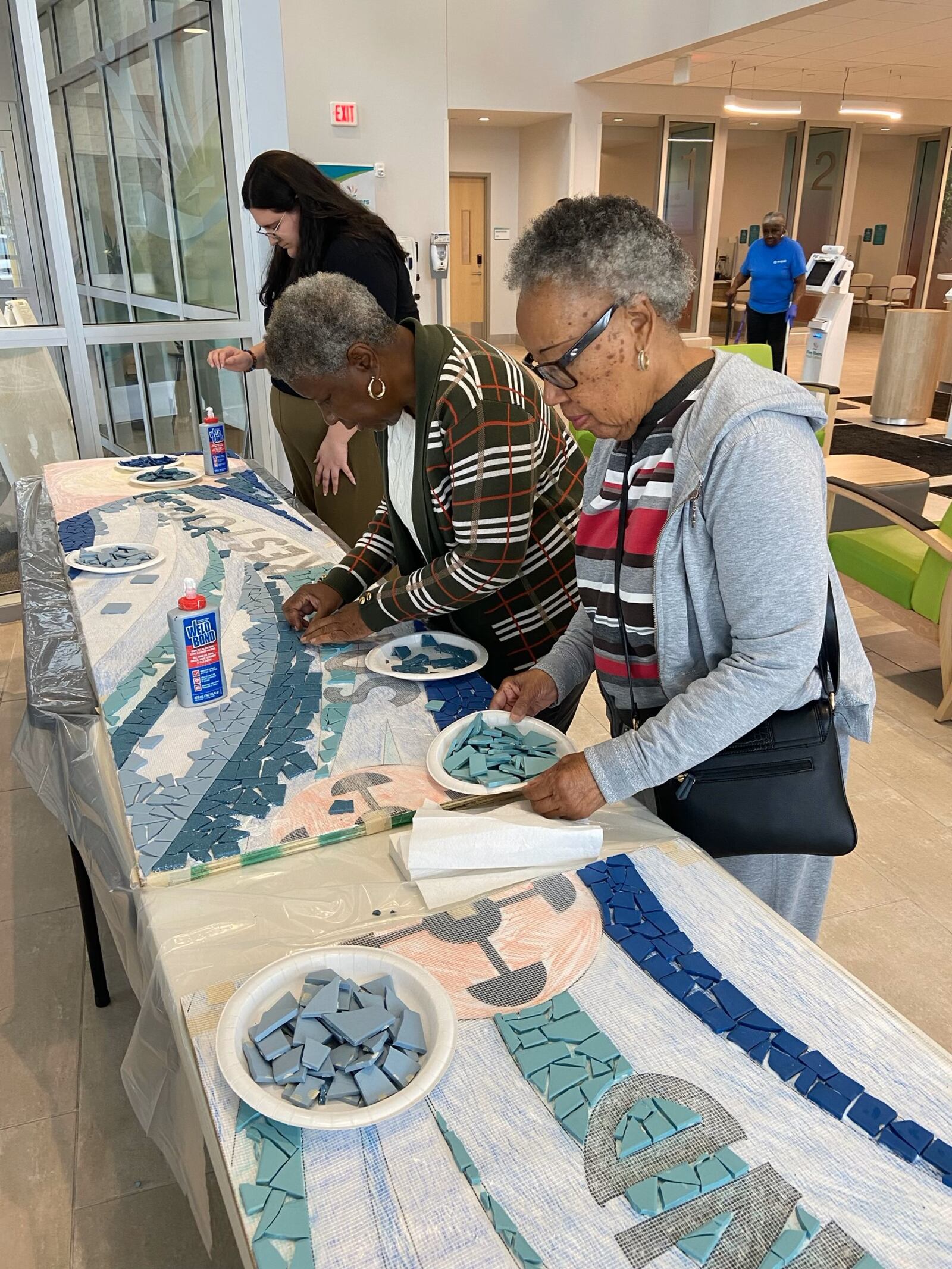 Edgemont community members add tiles to mosaic. CONTRIBUTED