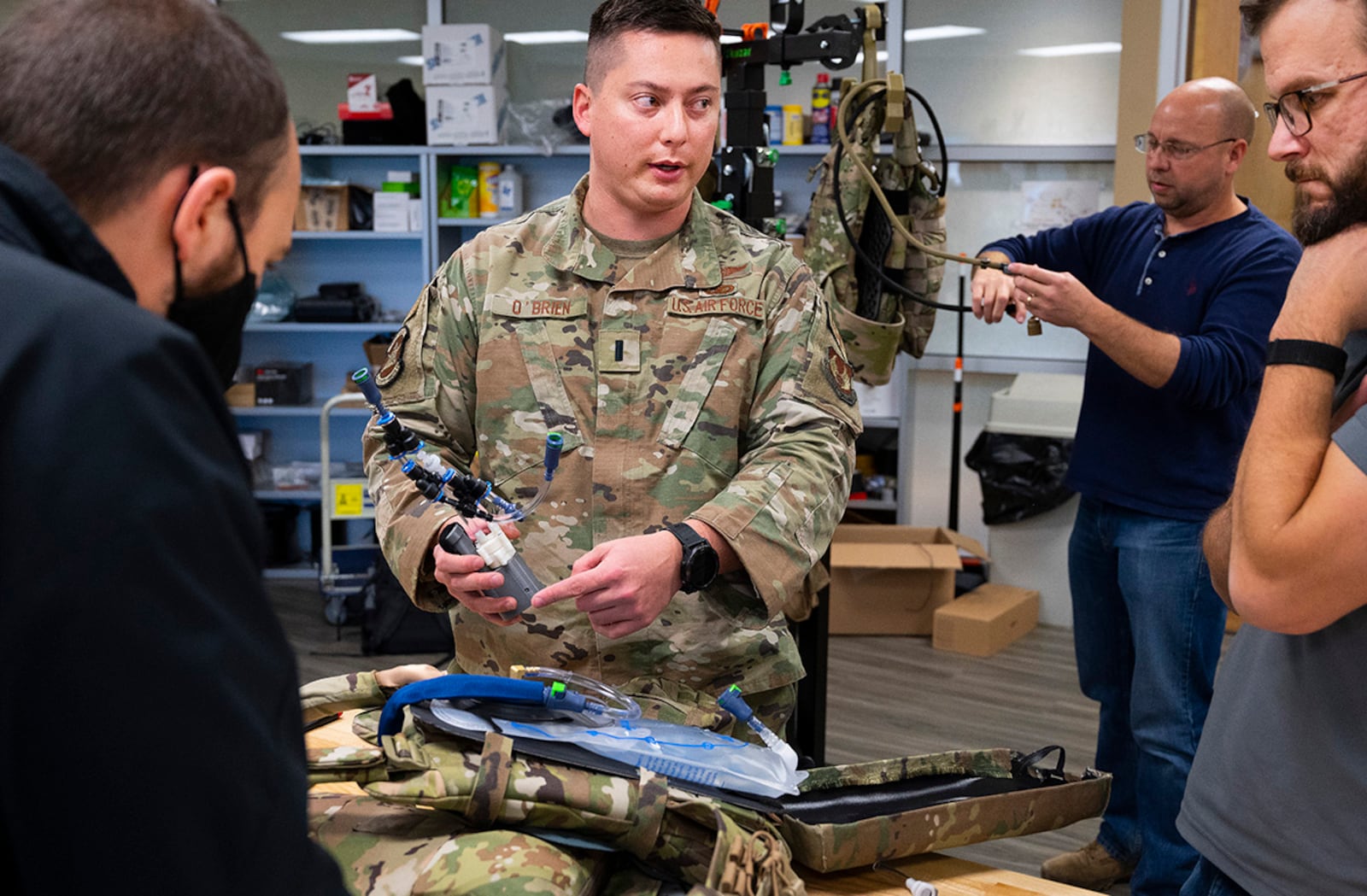 First Lt. Justin O’Brien, 88th Security Forces Squadron, consults with Wright Brothers Institute and Air Force Research Laboratory engineers Dec. 1 as they build a prototype of the liquid-cooled plate carrier. O’Brien entered his design in Air Force Materiel Command’s Spark Tank competition, catching the attention Air Force leadership. U.S. AIR FORCE PHOTO/R.J. ORIEZ