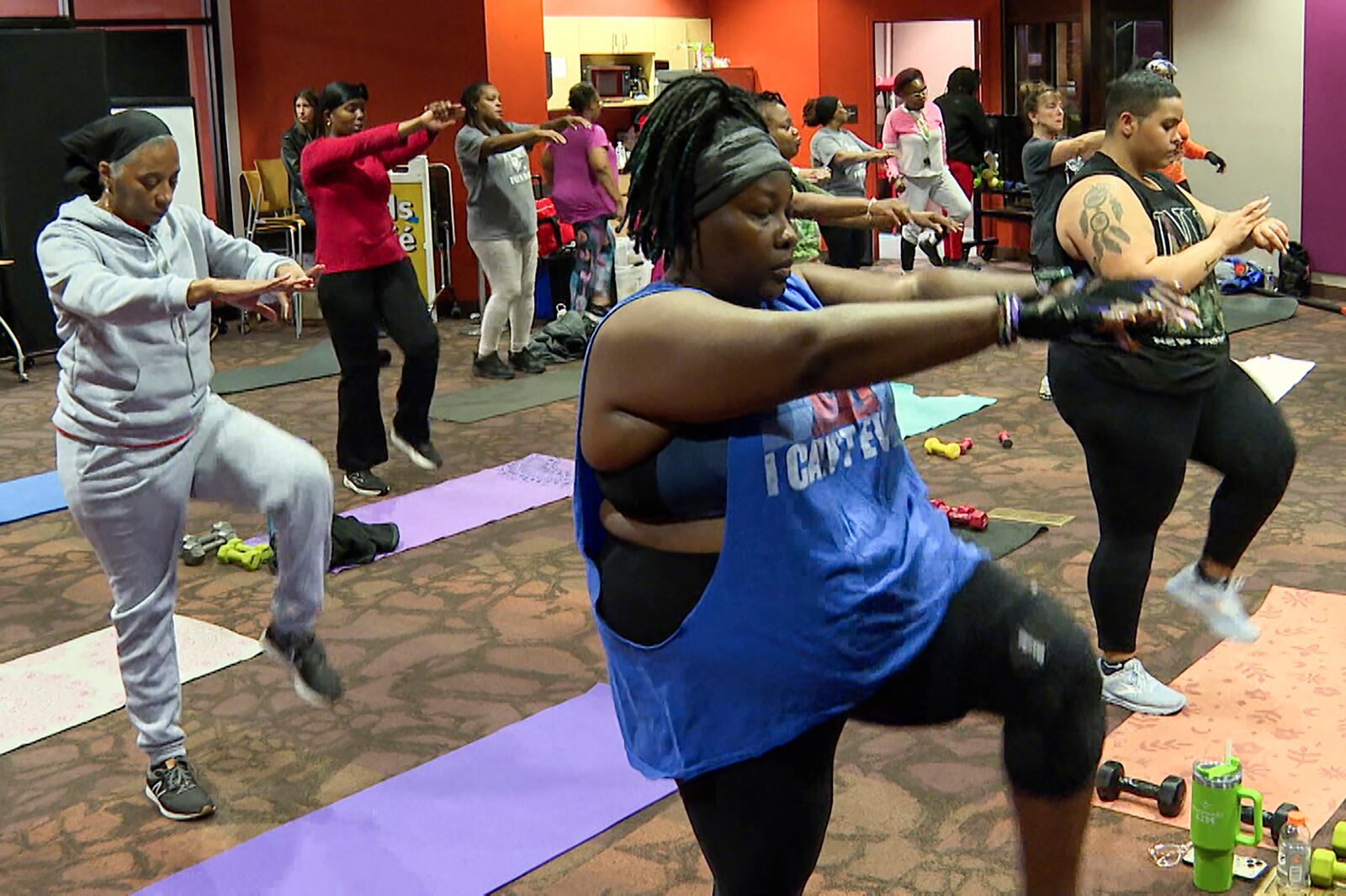 Attendees stretch during a fitness class at the public library in Kansas City, Mo., on Nov. 19, 2024. (AP Photo/Nick Ingram)