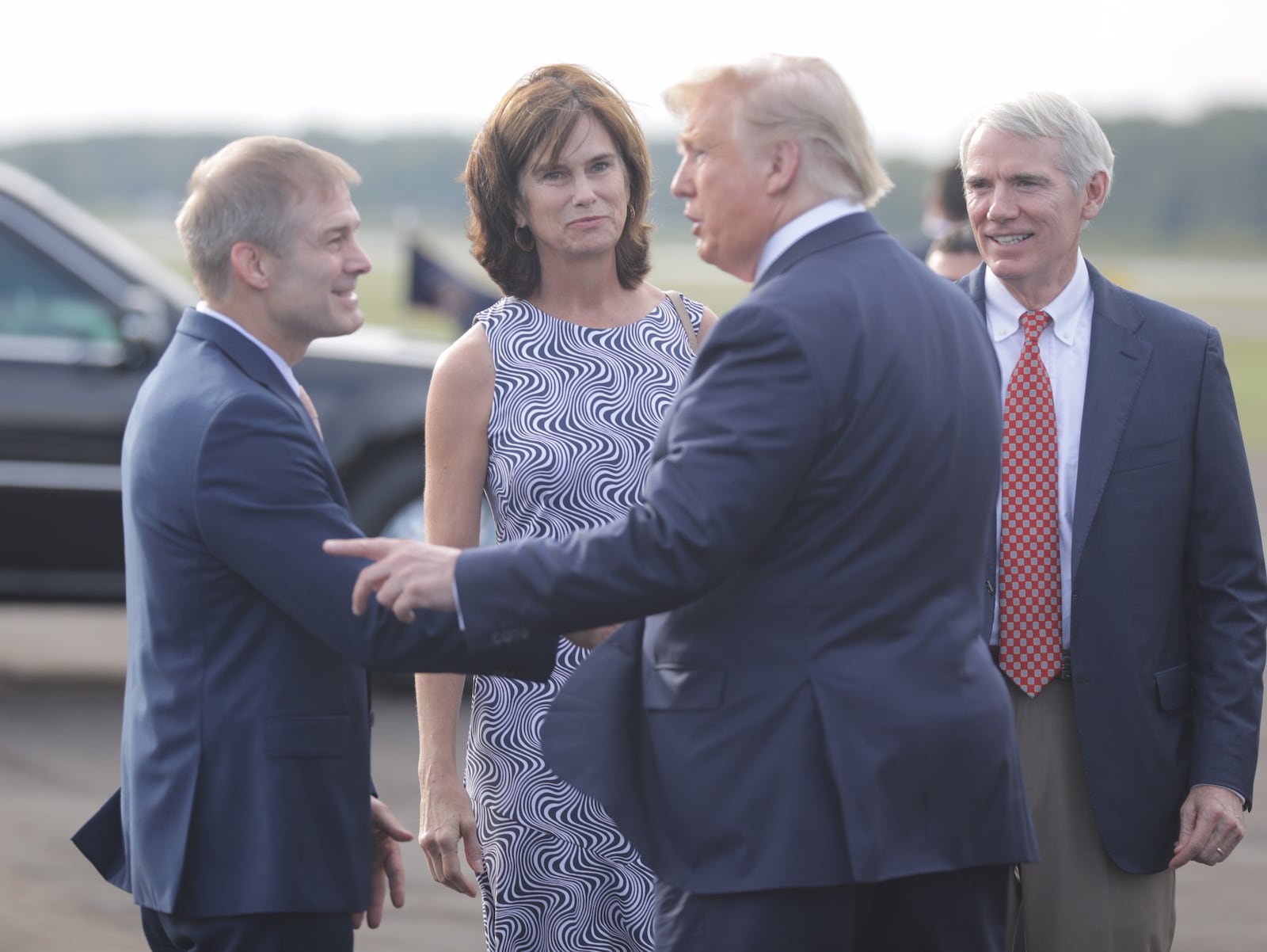 President Donald Trump meets Congressman Jim Jordan and Sen. Rob Portman and Jane Portman at the Lima airport on Sunday. Photo by Bill Lackey.