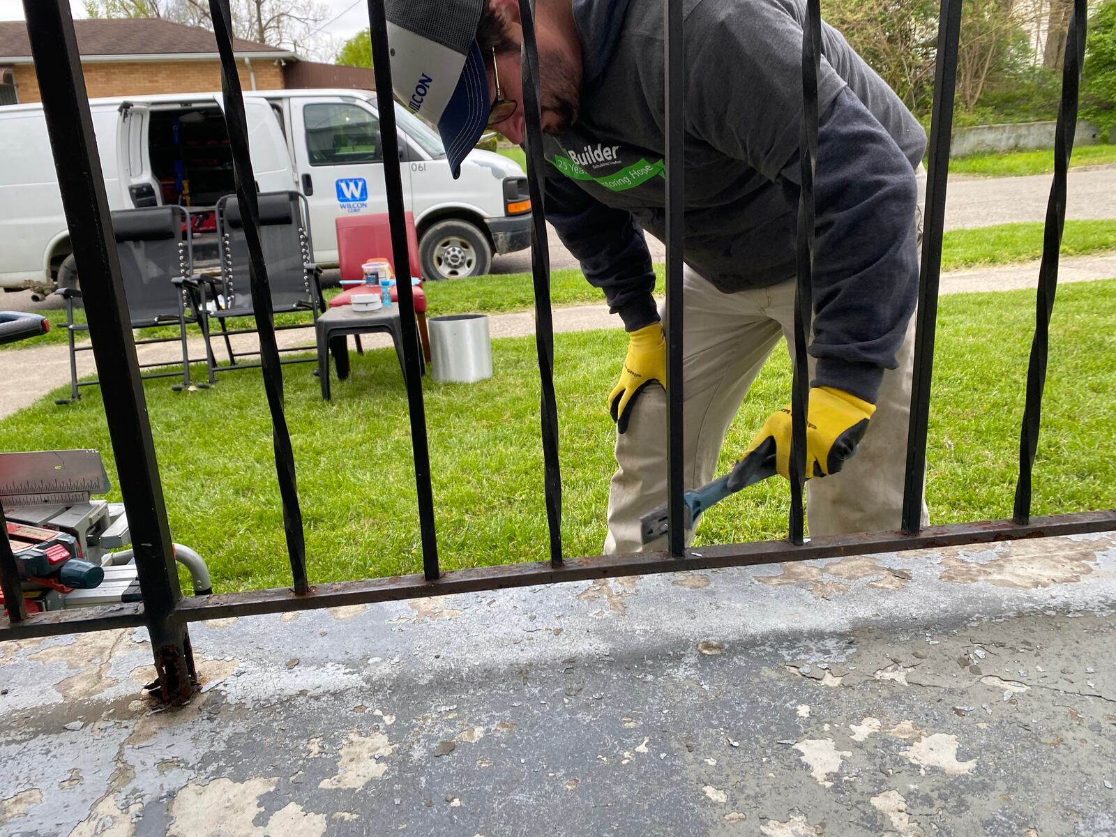 Dennis Niemeijer works on Marilyn Watson’s front porch. Niemeijer was the house captain at Watson’s home on Saturday. The work was done through Rebuilding Together Dayton, a local nonprofit, and the house workers were from Wilcon Corporation. EILEEN McCLORY STAFF