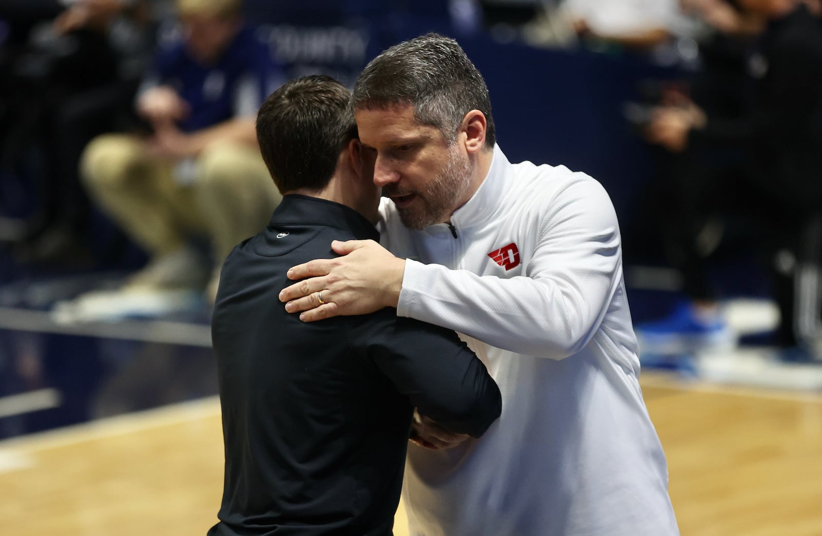 Dayton trainer Mike Mulcahey, right, hugs Rhode Island's Archie Miller before the game on Wednesday, Jan. 25, 2023, at the Ryan Center in Kingston, R.I. David Jablonski/Staff