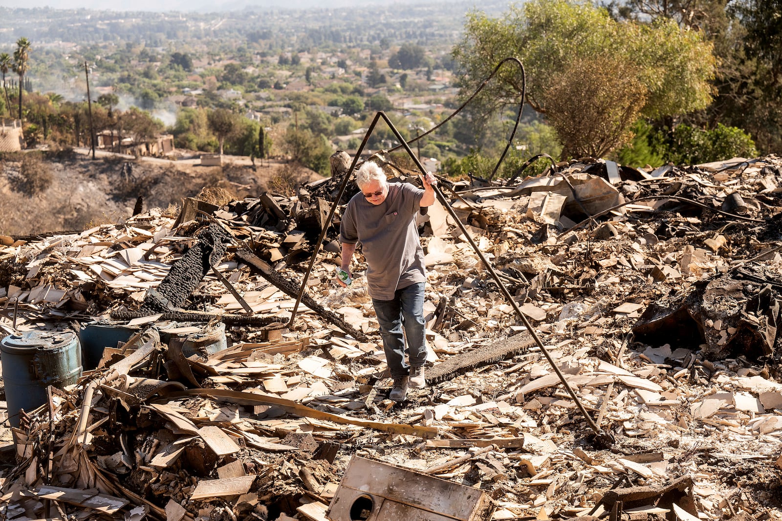 Joey Parish walks through his home, Friday, Nov. 8, 2024, which was destroyed by the Mountain Fire in Camarillo, Calif. (AP Photo/Noah Berger)