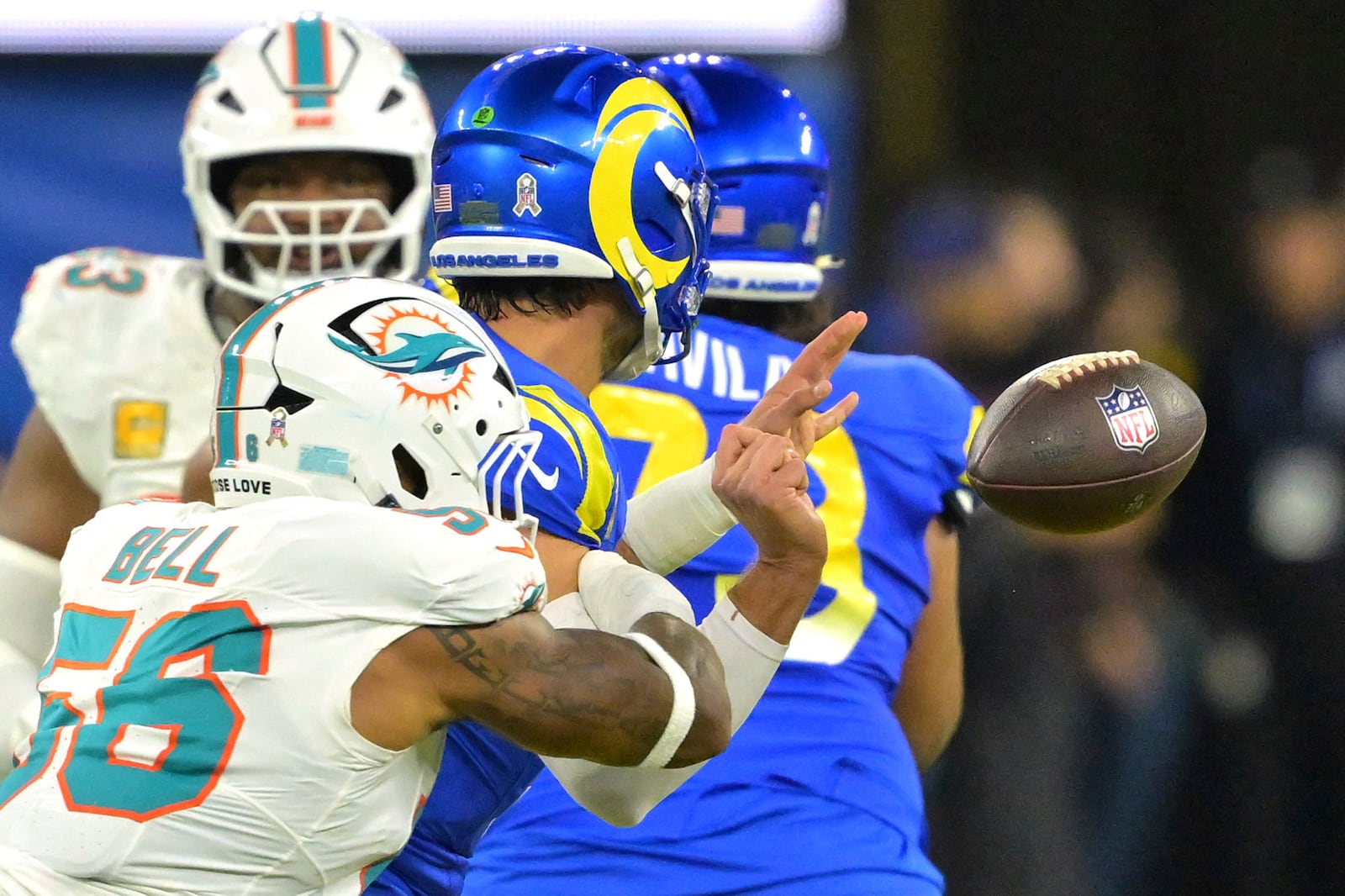 Miami Dolphins linebacker Quinton Bell, left, causes Los Angeles Rams quarterback Matthew Stafford to fumble the ball during the first half of an NFL football game, Monday, Nov. 11, 2024, in Inglewood, Calif. (AP Photo/Jayne Kamin-Oncea)