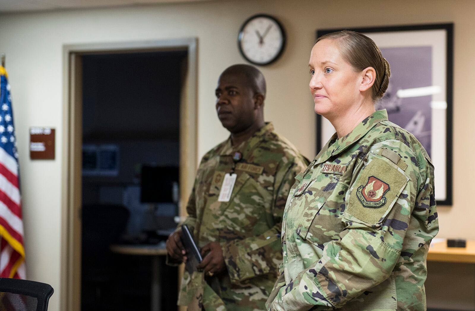 Chief Master Sgt. Benito Hibbert (left), 88th Medical Group senior enlisted leader, and Master Sgt. Dayna Wray, Medical Readiness Flight chief for the 88th Medical Support Squadron, listen to a briefing on 88 MDG’s deployment capabilities and operational tempo during a March 10 visit by Chief Master Sgt. David Flosi, Air Force Materiel Command command chief. U.S. AIR FORCE PHOTO/JAIMA FOGG