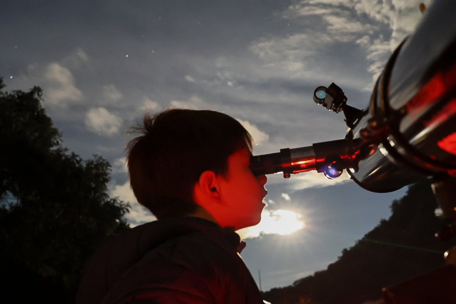 FILE - A youth looks through a telescope during a stargazing and comet-watching gathering at Joya-La Barreta Ecological Park in Queretaro, Mexico, Saturday, Oct. 19, 2024. (AP Photo/Ginnette Riquelme, File)