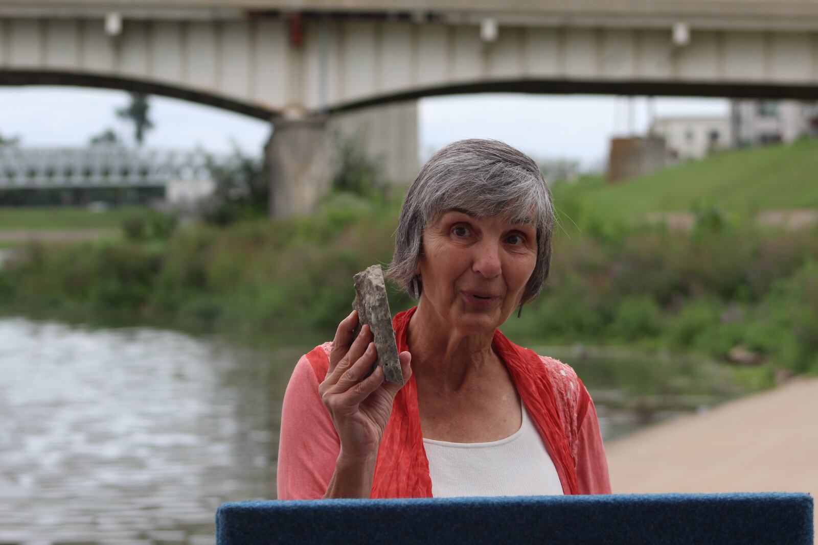 Carrie Scarff, director of planning and projects with Five Rivers MetroParks, holds up a chunk of concrete that came off the Patterson Boulevard bridge in downtown Dayton. CORNELIUS FROLIK / STAFF