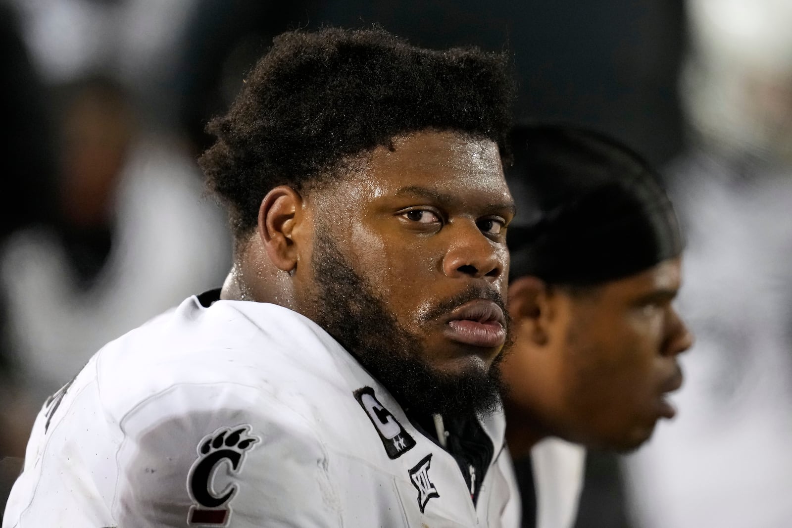 Cincinnati defensive tackle Dontay Corleone sits on the bench during the second half of an NCAA college football game against Iowa State, Saturday, Nov. 16, 2024, in Ames, Iowa. (AP Photo/Charlie Neibergall)