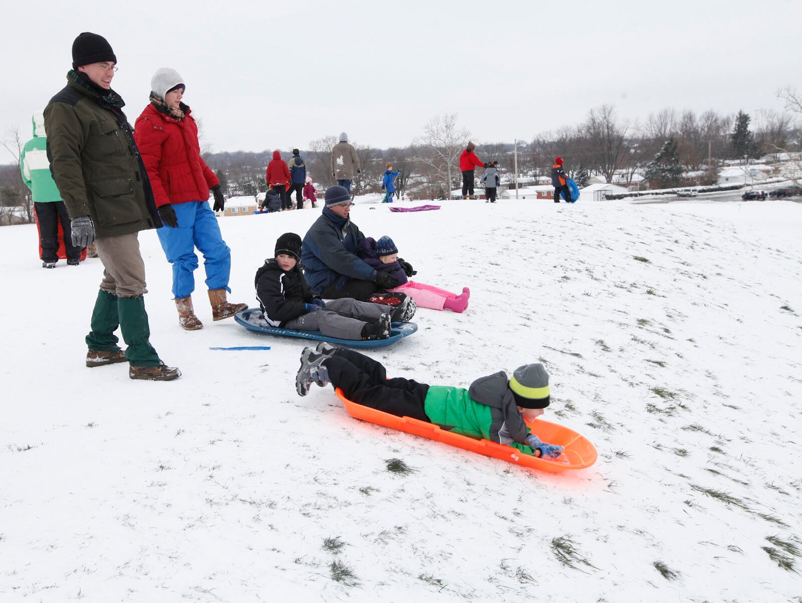 Sledders take to the hill at Indian Riffle Park in Kettering. CHRIS STEWART / STAFF