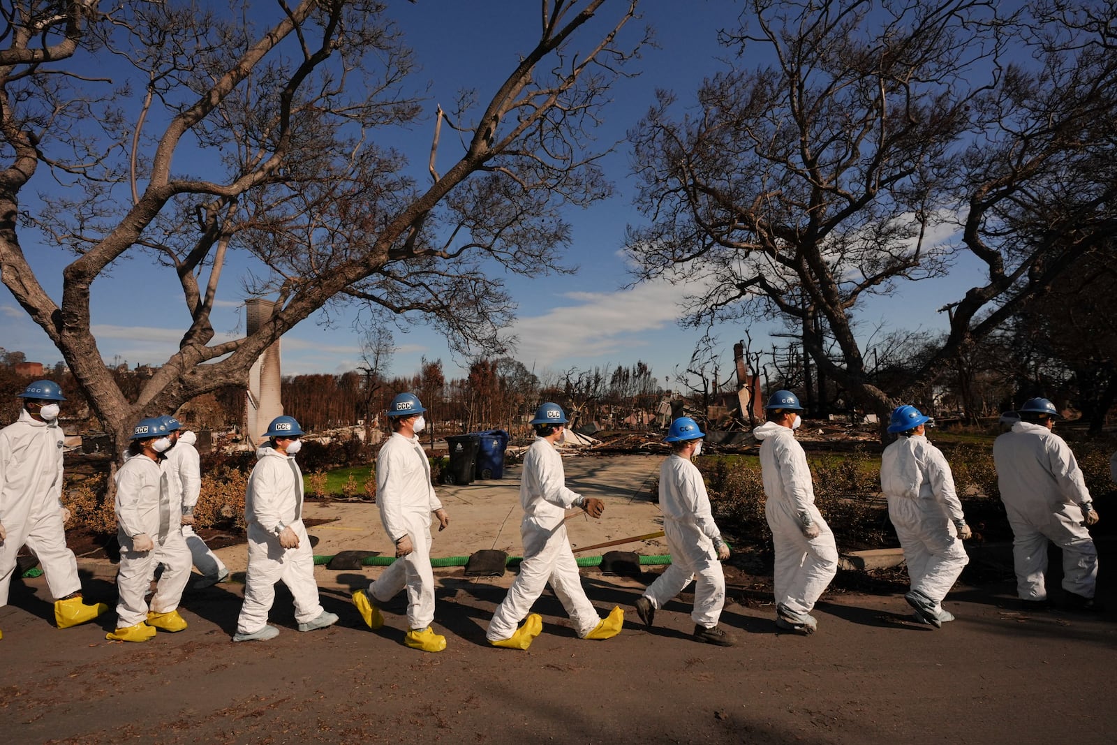 Members of California Conservation Corps work in the rubble of the Palisades Fire in the Pacific Palisades section of Los Angeles, Monday, Jan. 27, 2025. (AP Photo/Jae C. Hong)