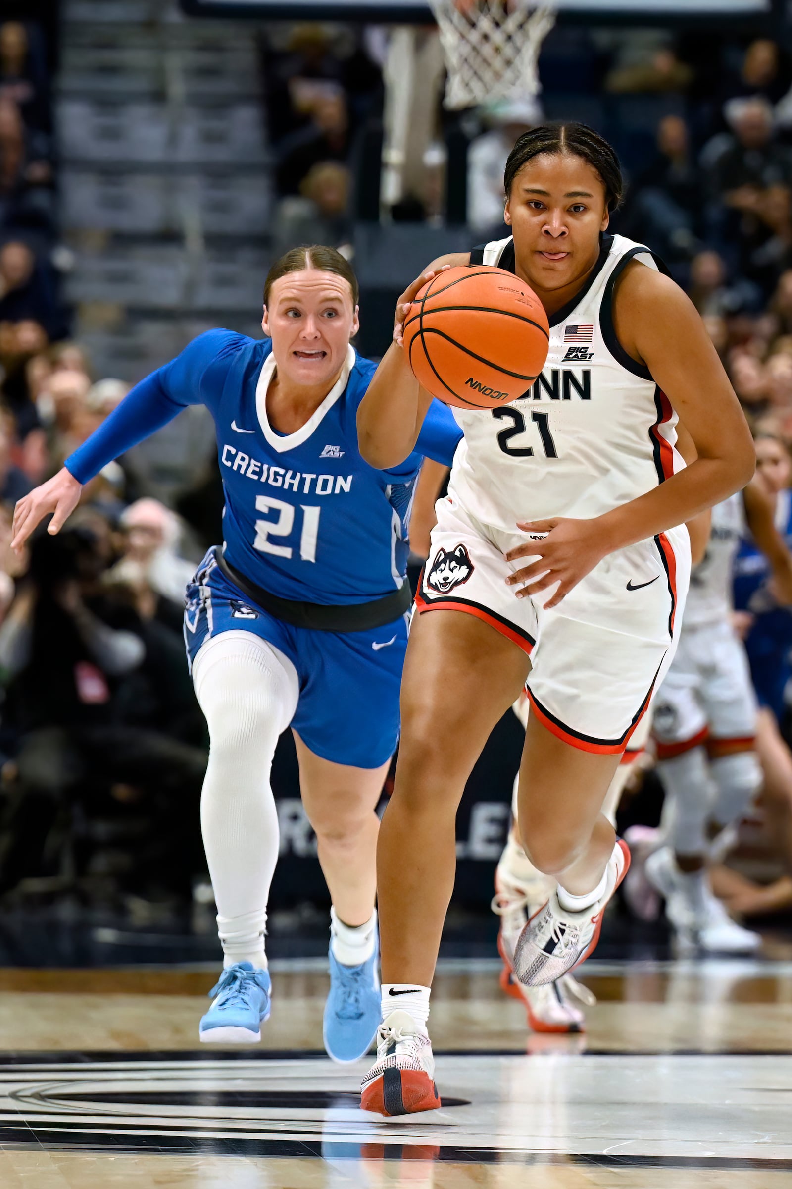 UConn forward Sarah Strong (21) steals the ball from Creighton guard Molly Mogensen (21) in the first half of an NCAA college basketball game, Thursday, Feb. 27, 2025, in Hartford, Conn. (AP Photo/Jessica Hill)