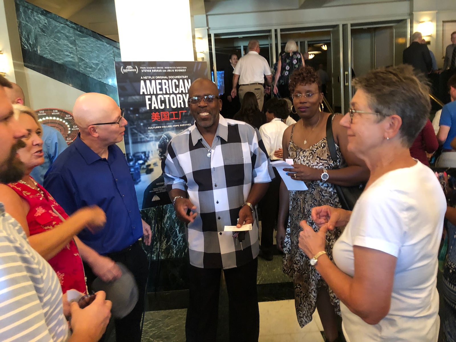 “American Factory”  from Oscar-nominated filmmakers Steve Bognar and Julia Reichert made its theatrical debut Monday, Aug. 19 at the Victoria Theatre in downtown Dayton.  Bognar and Reichert (blue and white shirts) are pictured with Louis Carter and Shawnea Rosser Carter (center), Jill Lamantia and an unidentified man.