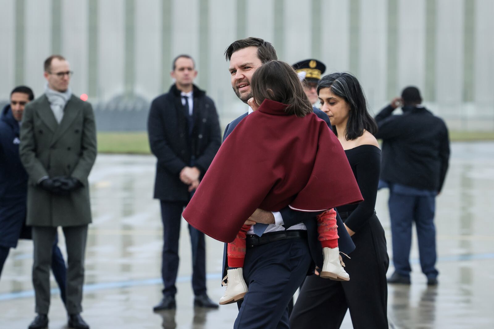 United States Vice-President JD Vance, center, carries his daughter Mirabel as he arrives at Paris Orly Airport with second lady Usha Vance, ahead of an Artificial Intelligence Action Summit taking place in Paris, Monday, Feb. 10, 2025. (AP Photo/Thomas Padilla)