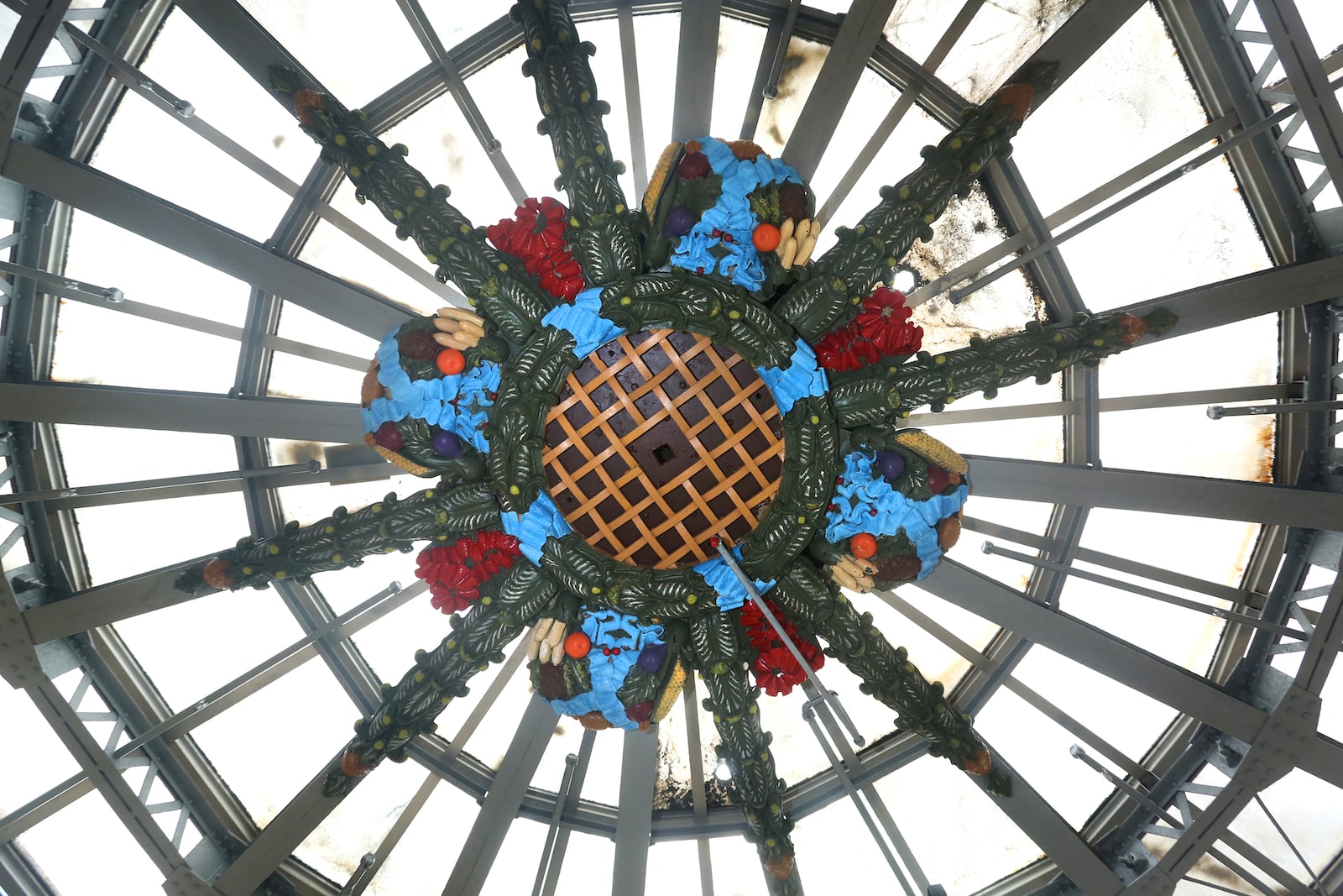 If you look directly up to the center of the Dayton Arcade dome you will see a cornucopia of fruits and vegetables. Loca artist John Landsiedel has cleaned and repainted the artwork. LISA POWELL / STAFF