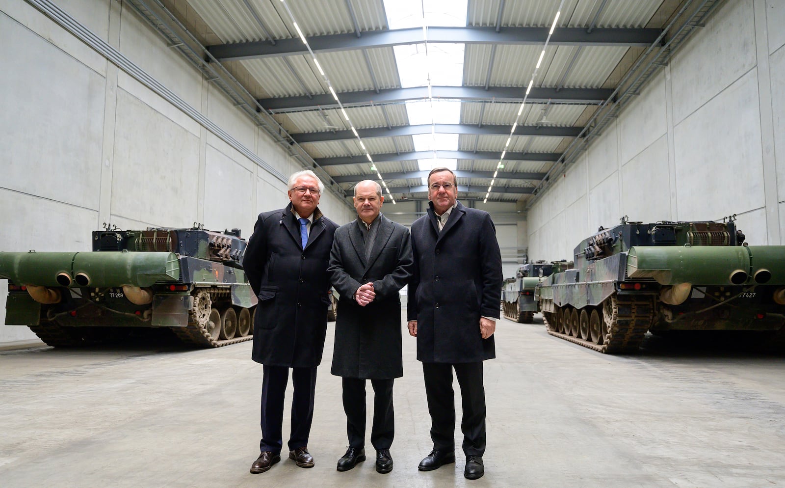 FILE - Rheinmetall CEO Armin Papperger, from left, German Chancellor Olaf Scholz and German Defense Minister Boris Pistorius stand in a hall with Leopard 2A4 main battle tanks in Unterluess, Germany, Feb. 12, 2024. (Philipp Schulze/dpa via AP, File)