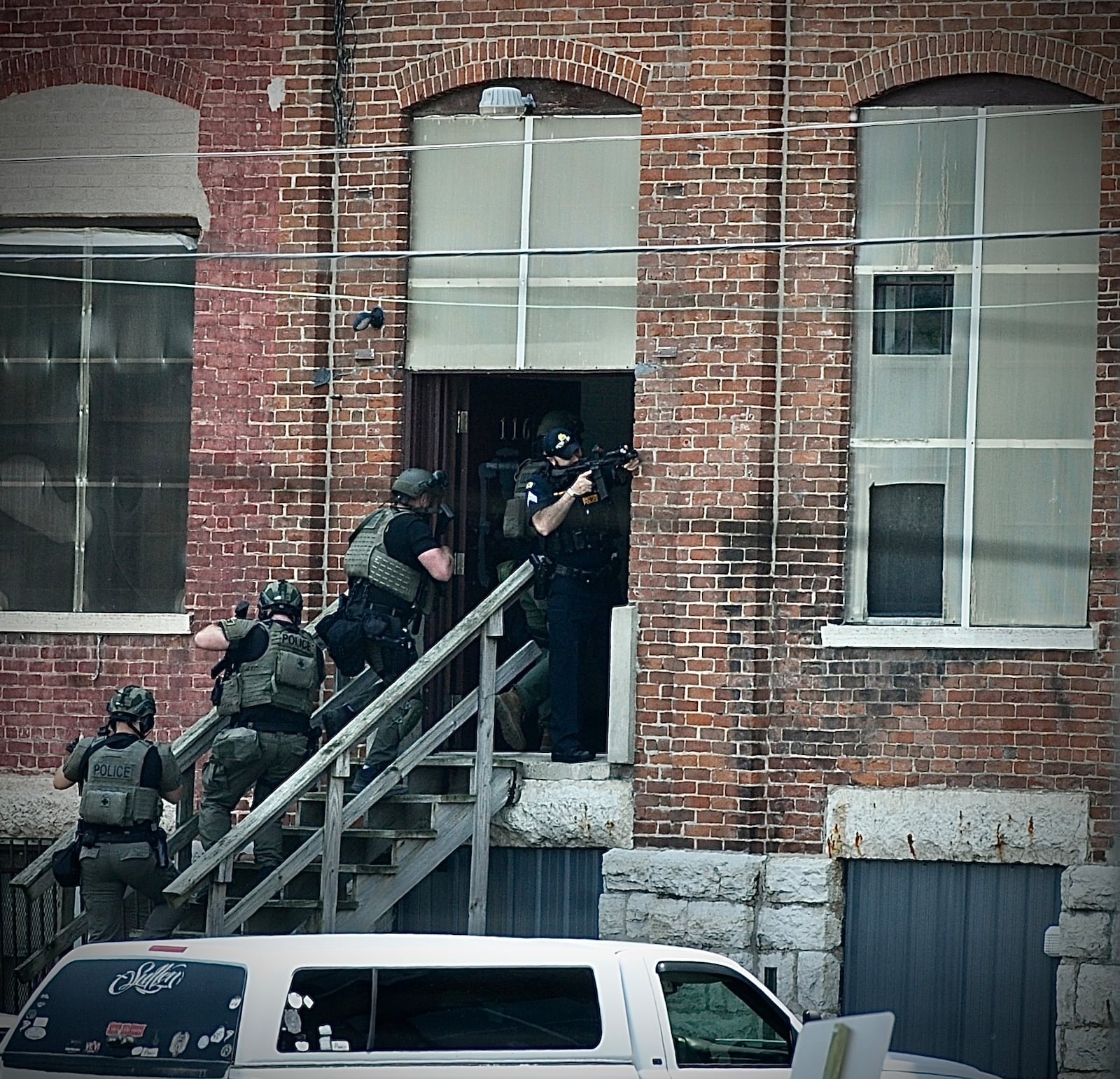 SWAT team members enter the Davis Linden building. MARSHALL GORBY/STAFF