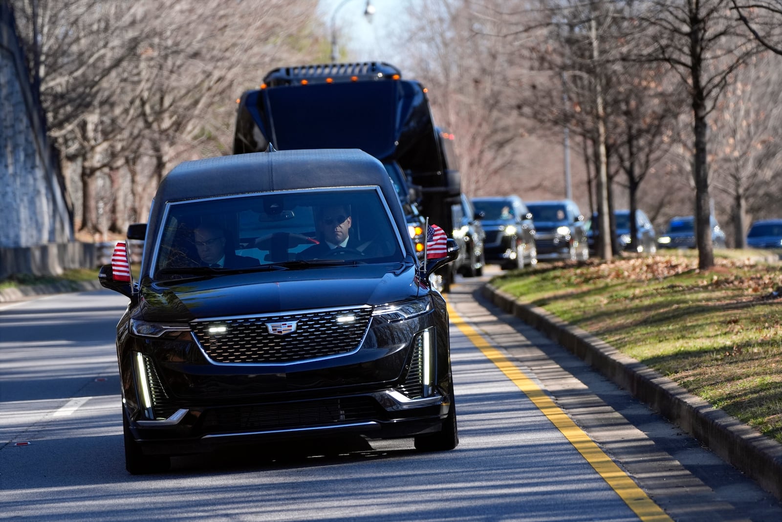 The motorcade carrying the casket of former President Jimmy Carter departs the Jimmy Carter Presidential Library and Museum in Atlanta, Tuesday, Jan. 7, 2025. Carter died Dec. 29 at the age of 100. (AP Photo/Alex Brandon, Pool)