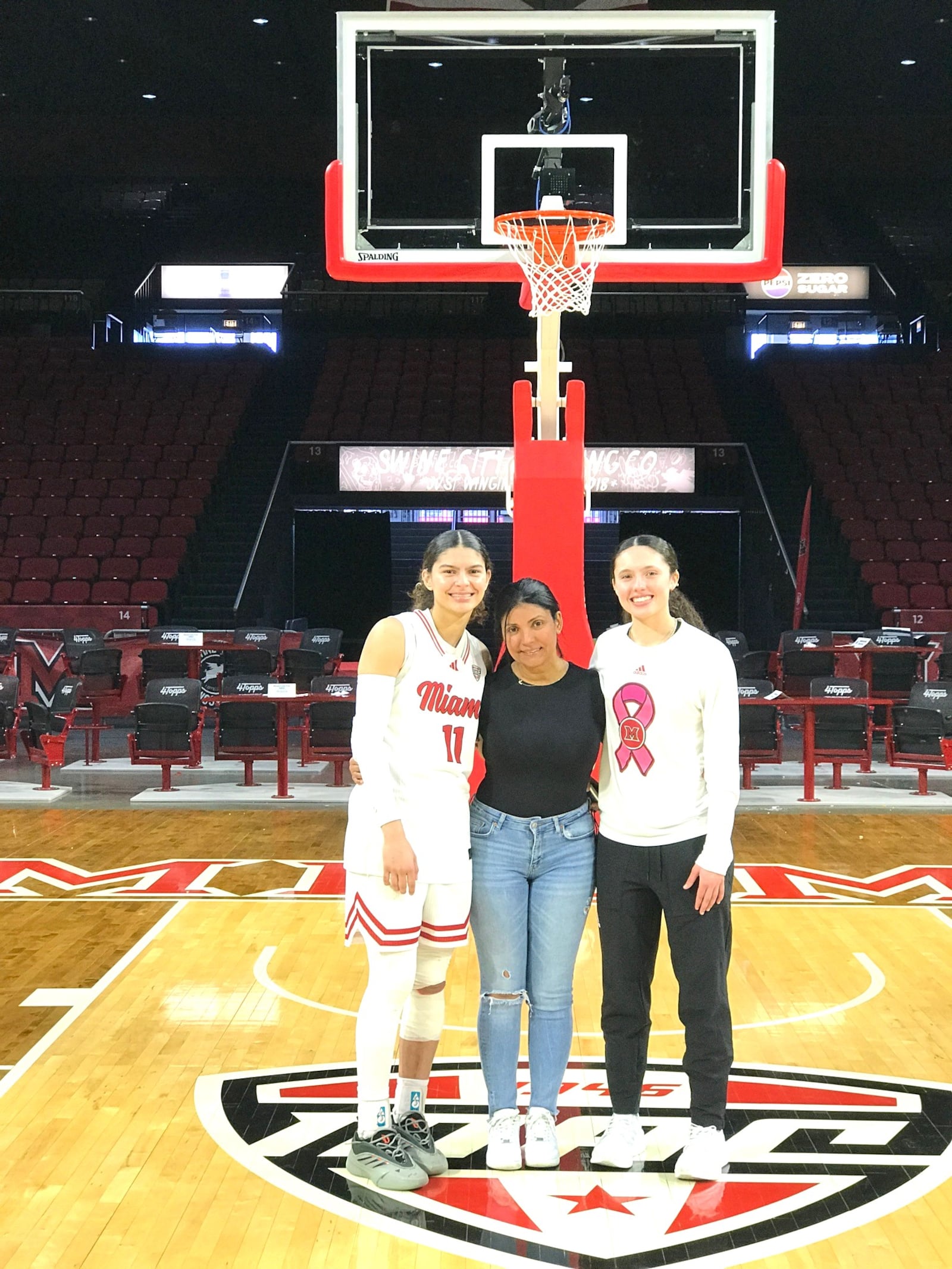 Delores “Lola” Montadas flanked by her daughters Enjulina (left) and Ziul on the Millett Hall court Saturday after the RedHawks defeated Northern Illinois, 89-79. Enjulina had 22 points and six steals in that game. Tom Archdeacon/CONTRIBUTED