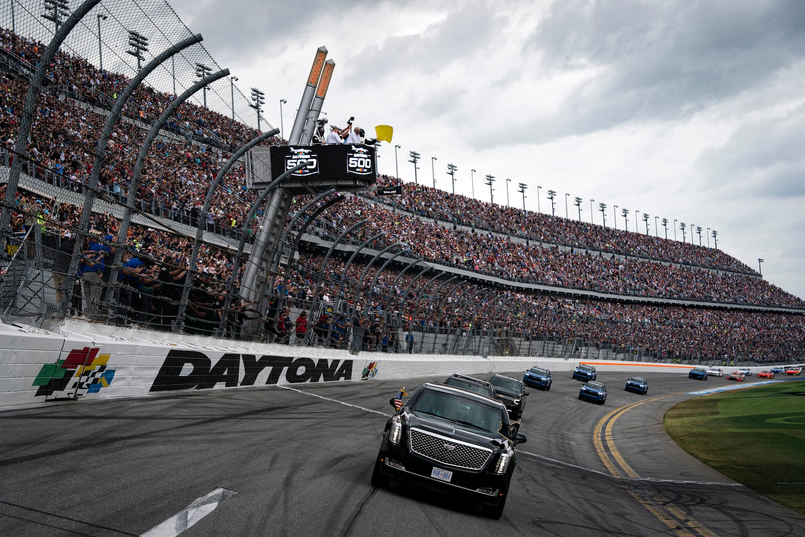 President Donald Trump rides in the presidential limousine known as "The Beast" as he takes a pace lap ahead of the start of the NASCAR Daytona 500 auto race at Daytona International Speedway, Sunday, Feb. 16, 2025, in Daytona Beach, Fla. (Pool via AP)