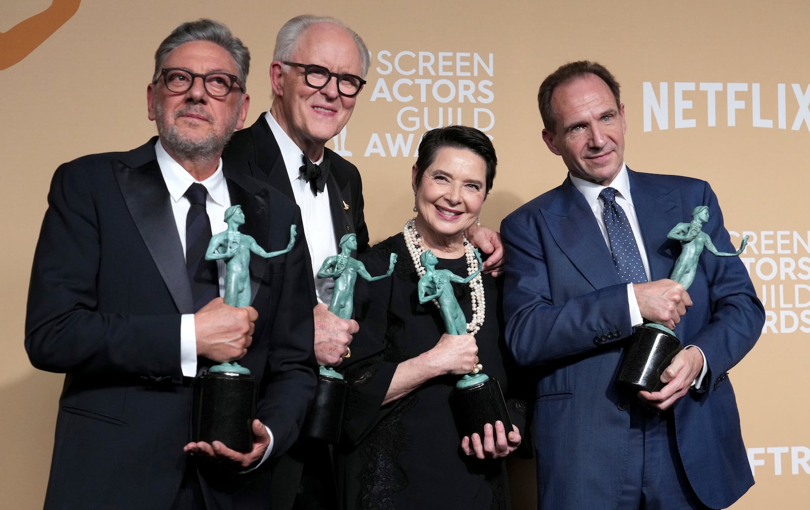 Sergio Castellitto, from left, John Lithgow, Isabella Rossellini, and Ralph Fiennes, winners of the award for outstanding performance by a cast in a motion picture for "Conclave," pose in the press room during the 31st annual Screen Actors Guild Awards on Sunday, Feb. 23, 2025, at the Shrine Auditorium in Los Angeles. (Photo by Jordan Strauss/Invision/AP)