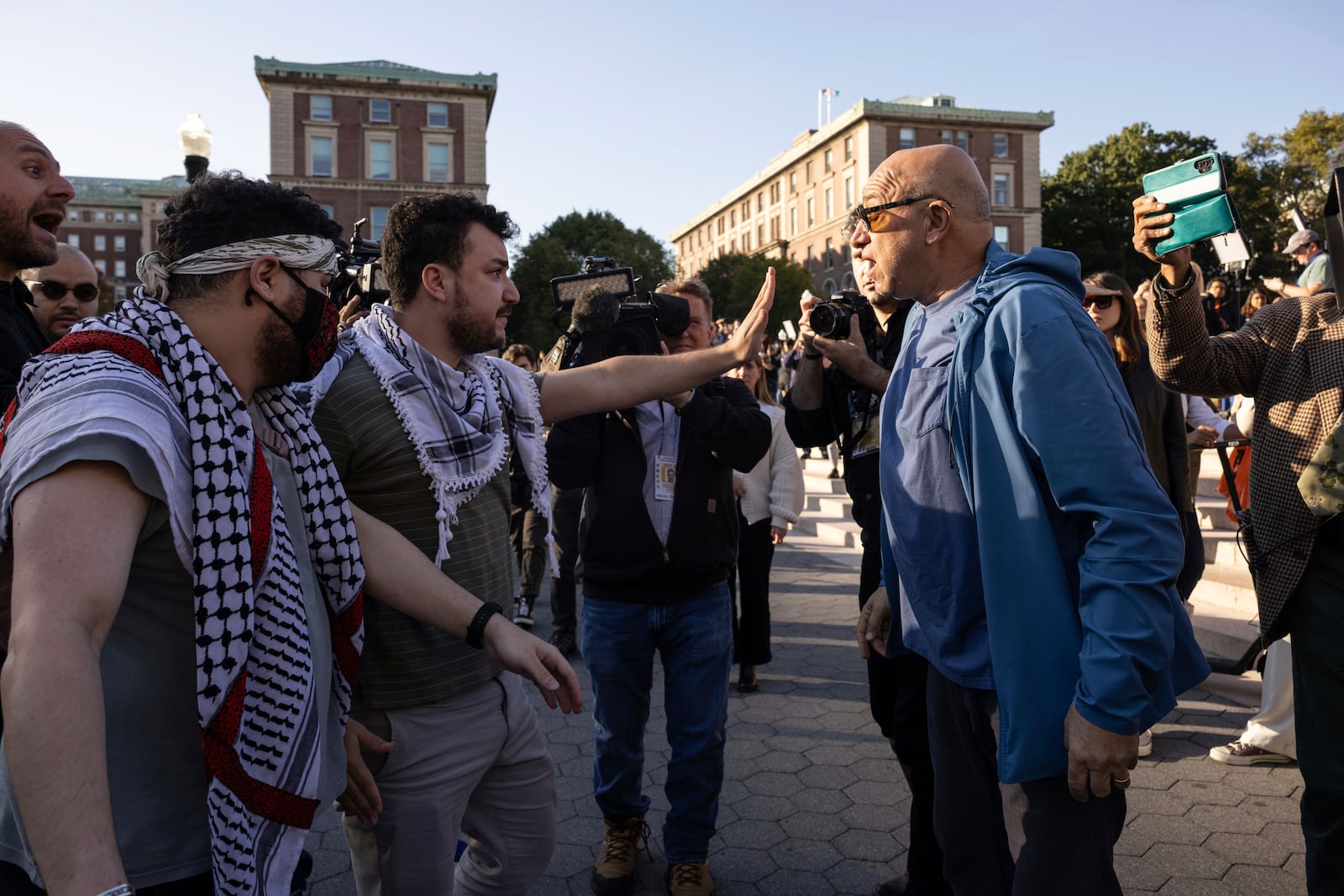 FILE - Pro-Palestinian demonstrator Mahmoud Khalil, second from left, debates with a pro-Israel demonstrator during a protest at Columbia University, Thursday, Oct. 12, 2023, in New York. (AP Photo/Yuki Iwamura, File)