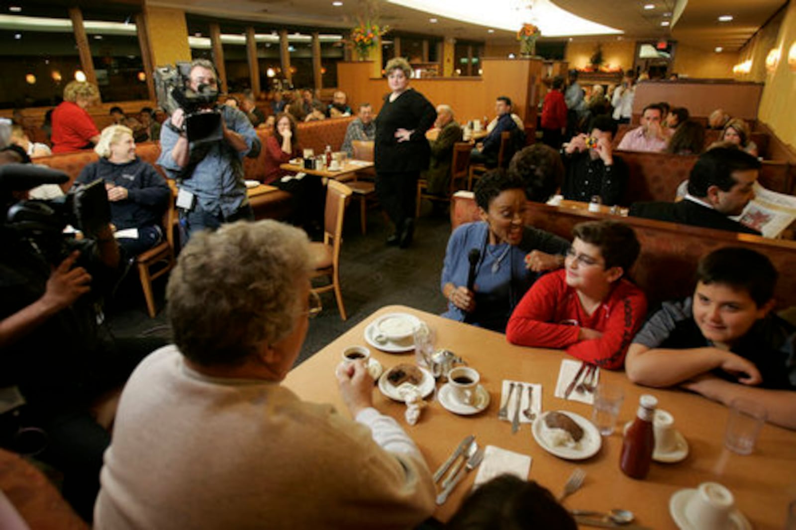 Good Morning America co-anchor Robin Roberts talks with Michael Frangomichalos, center in red and Laith Rashdan during a live segment at the Golden Nugget Pancake House in Kettering in 2008. JIM NOELKER / STAFF