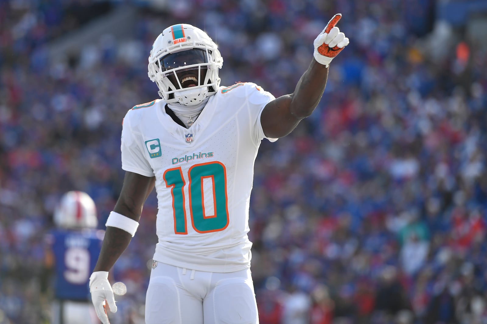 Miami Dolphins wide receiver Tyreek Hill (10) reacts after running back De'Von Achane (28) scored a touchdown during the first half of an NFL football game against the Buffalo Bills, Sunday, Nov. 3, 2024, in Orchard Park, N.Y. (AP Photo/Adrian Kraus)