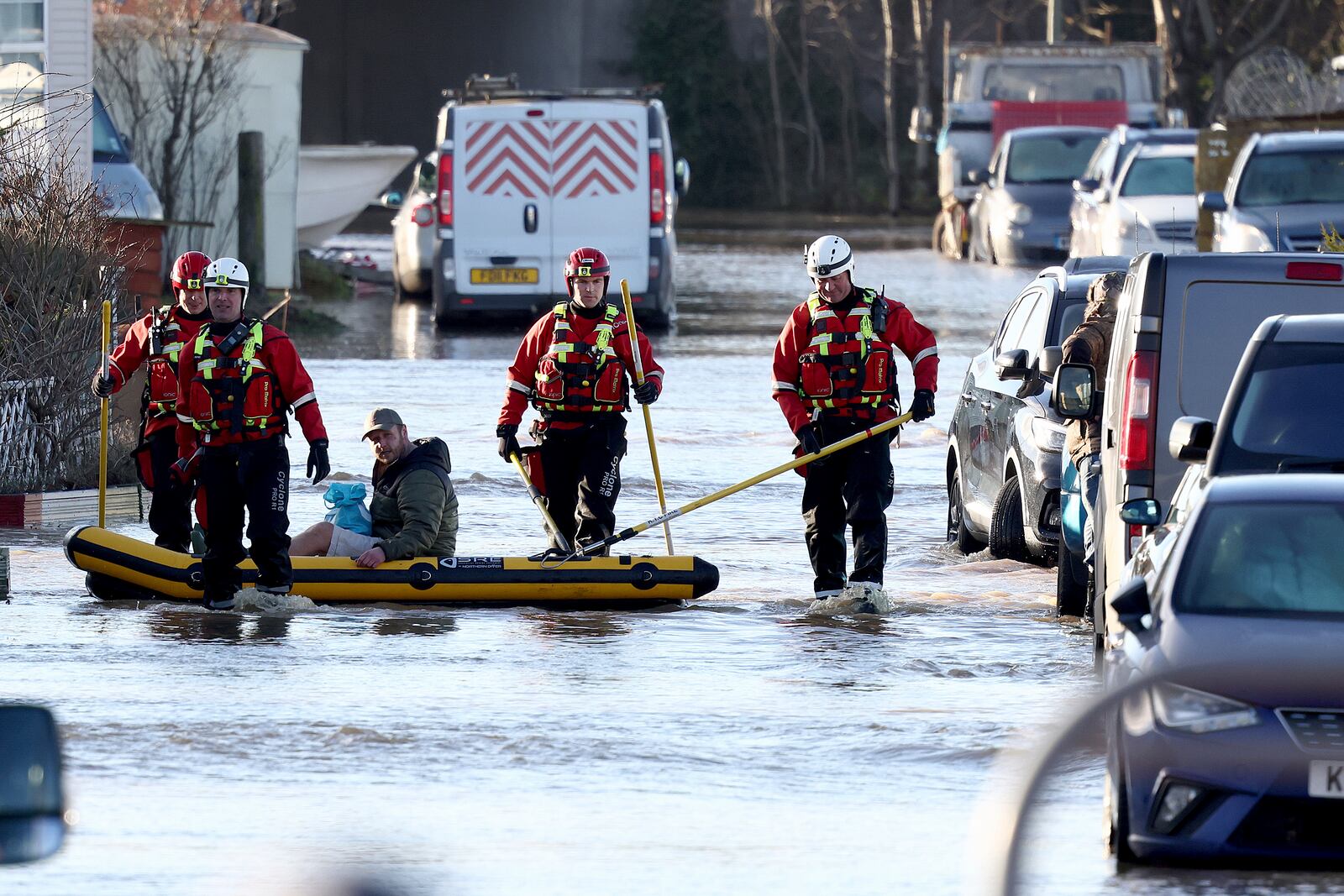 Firemen help residents in the flooded area of Barrow Upon Soar, England, Tuesday, Jan. 7, 2025.(AP Photo/Darren Staples)