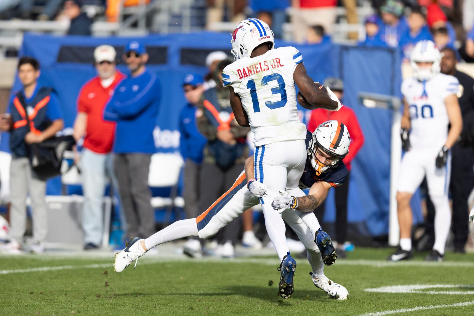 SMU wide receiver Roderick Daniels Jr. (13) is tackled by Virginia running back Davis Lane Jr. (25) during the second half of an NCAA college football game, Saturday, Nov. 23, 2024, in Charlottesville, Va. (AP Photo/Mike Kropf)