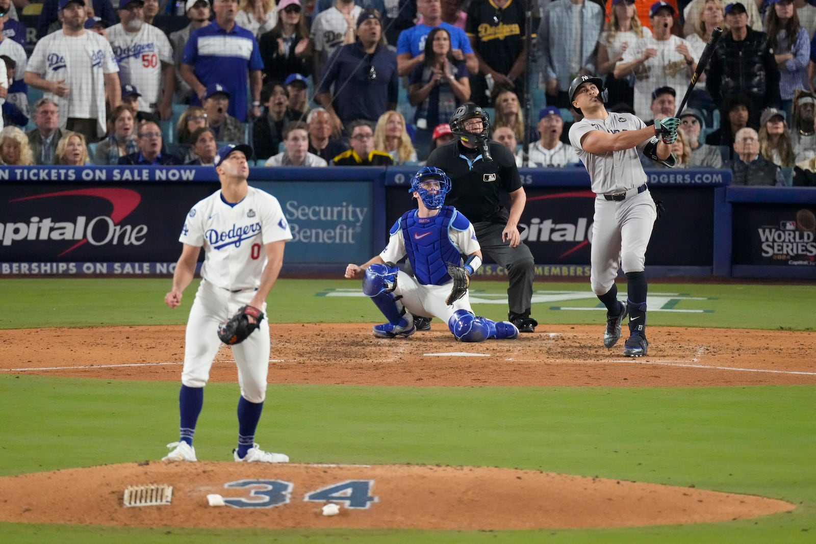 New York Yankees' Giancarlo Stanton watches his two-run home off Los Angeles Dodgers starting pitcher Jack Flaherty during the sixth inning in Game 1 of the baseball World Series, Friday, Oct. 25, 2024, in Los Angeles. (AP Photo/Mark J. Terrill)