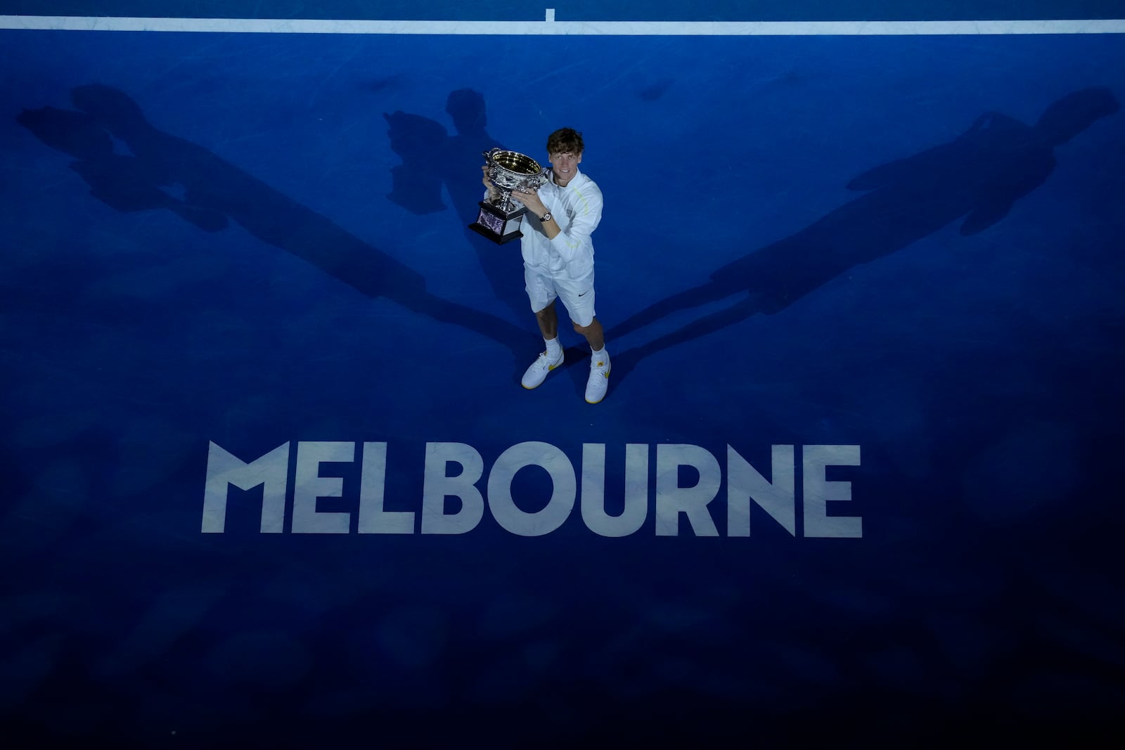 Jannik Sinner of Italy holds the Norman Brookes Challenge Cup after defeating Alexander Zverev of Germany in the men's singles final at the Australian Open tennis championship in Melbourne, Australia, Sunday, Jan. 26, 2025. (AP Photo/Manish Swarup)