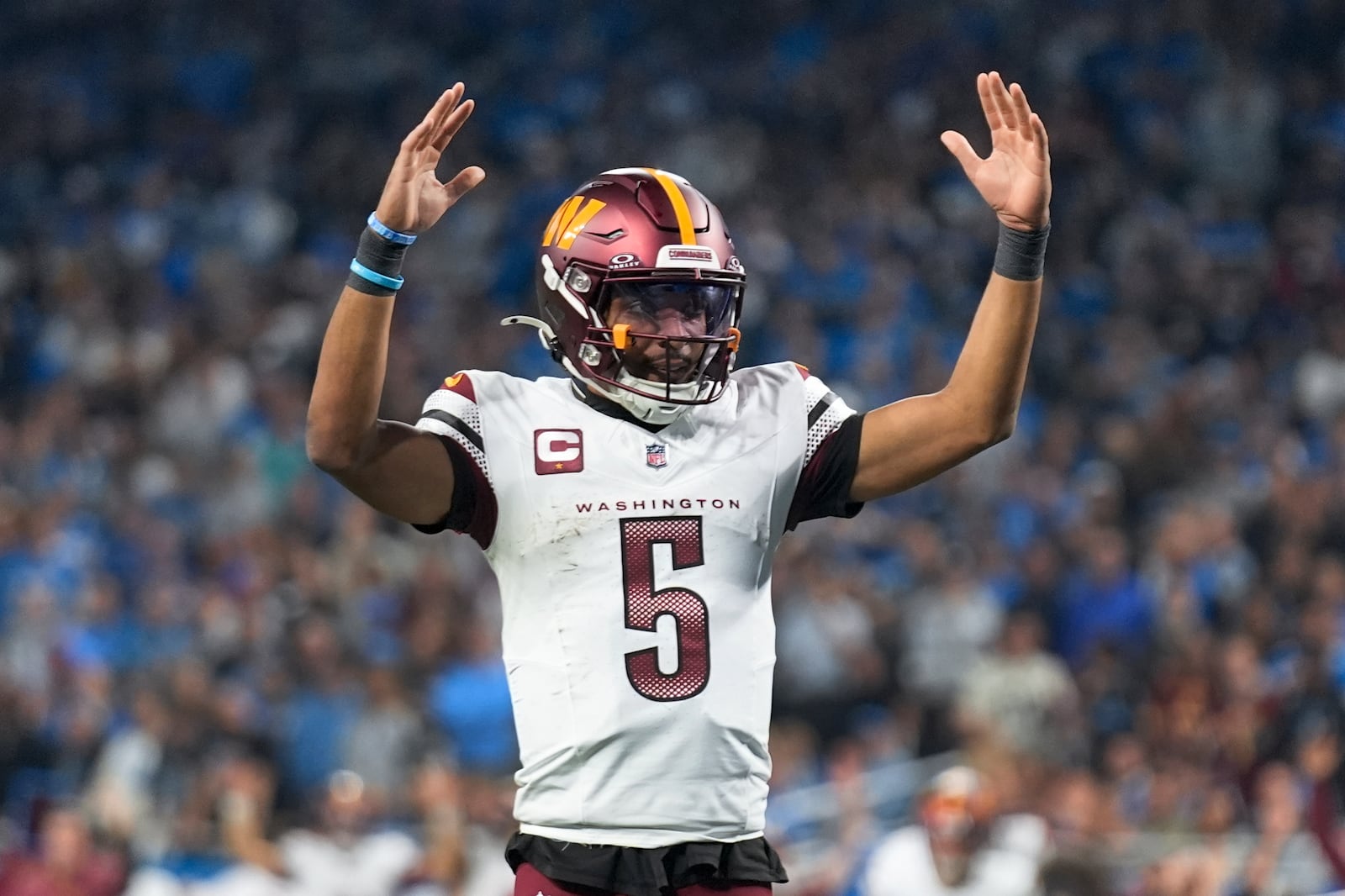 Washington Commanders quarterback Jayden Daniels (5) celebrates a touchdown against the Detroit Lions during the second half of an NFL football divisional playoff game, Saturday, Jan. 18, 2025, in Detroit. (AP Photo/Seth Wenig)