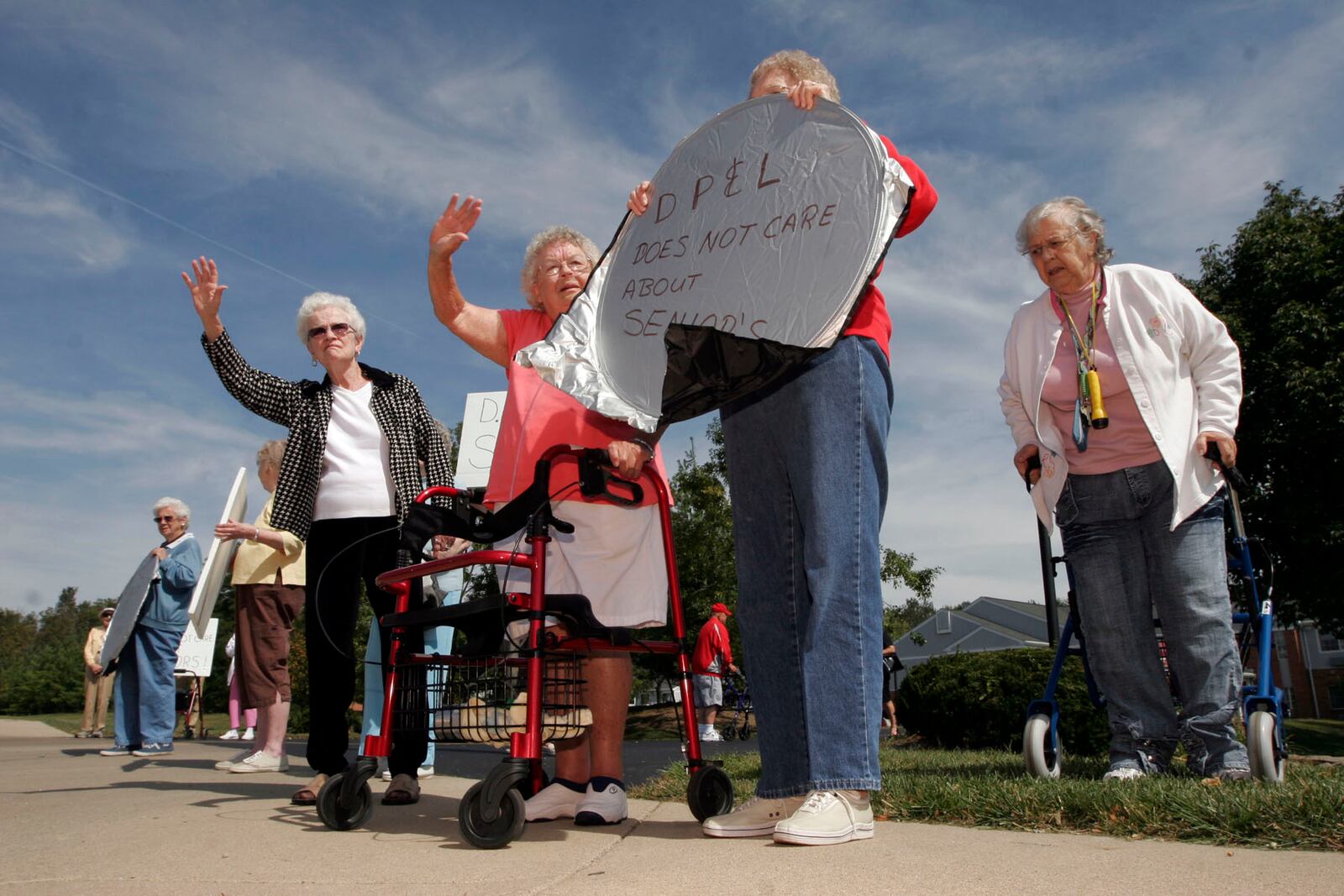 About 20 residents from Fairwood Village protest along N. Fairfield Rd. in Beavercreek Friday Sept. 19. Fairwood Village, an independent living facility with 81 residents with an average age of 85, has been without power since Sunday. Staff photo by Lisa Powell.