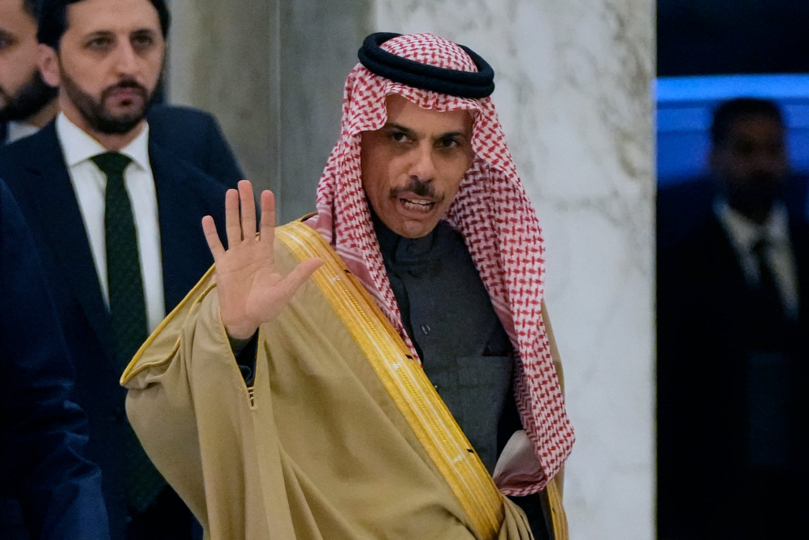 Saudi Arabia's Foreign Minister Prince Faisal bin Farhan al-Saud waves to journalists upon his arrival to meet with Lebanese President Joseph Aoun at the presidential palace in Baabda, east of Beirut, Lebanon, Thursday, Jan. 23, 2025. (AP Photo/Hassan Ammar)