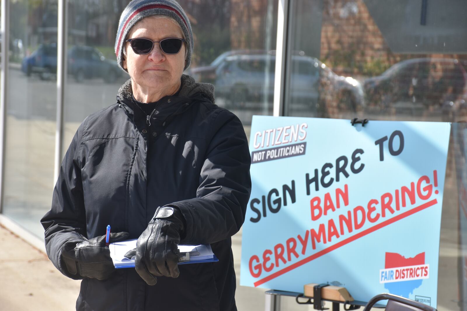 Joyce Gibbs, a volunteer with Citizens Not Politicians, collects signatures outside of a polling place in Kettering for a constitutional amendment that supporters say will get rid of gerrymandering in the drawing of political maps in Ohio. CORNELIUS FROLIK / STAFF